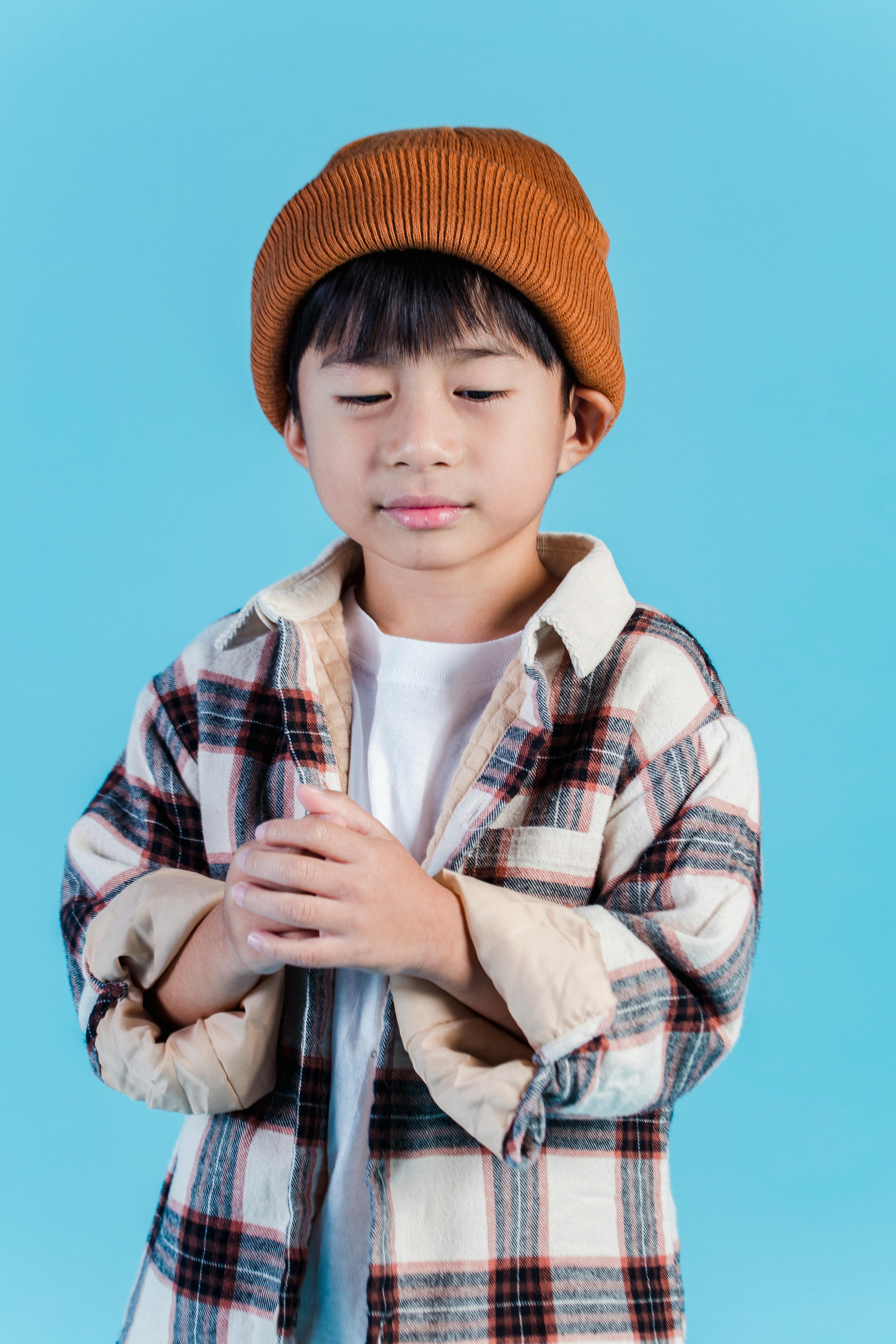 cute stylish asian boy standing in studio