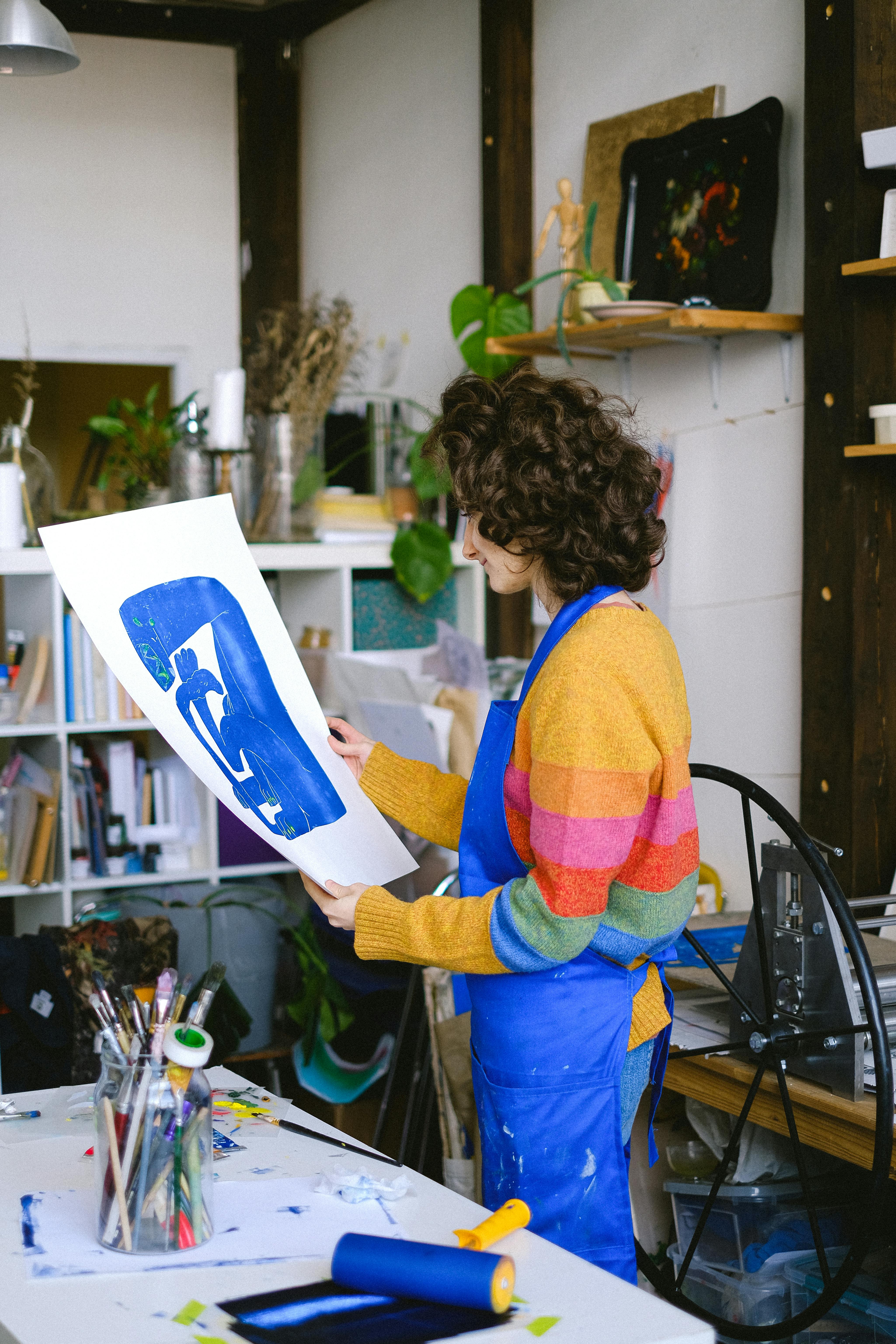 curly woman with painting in studio