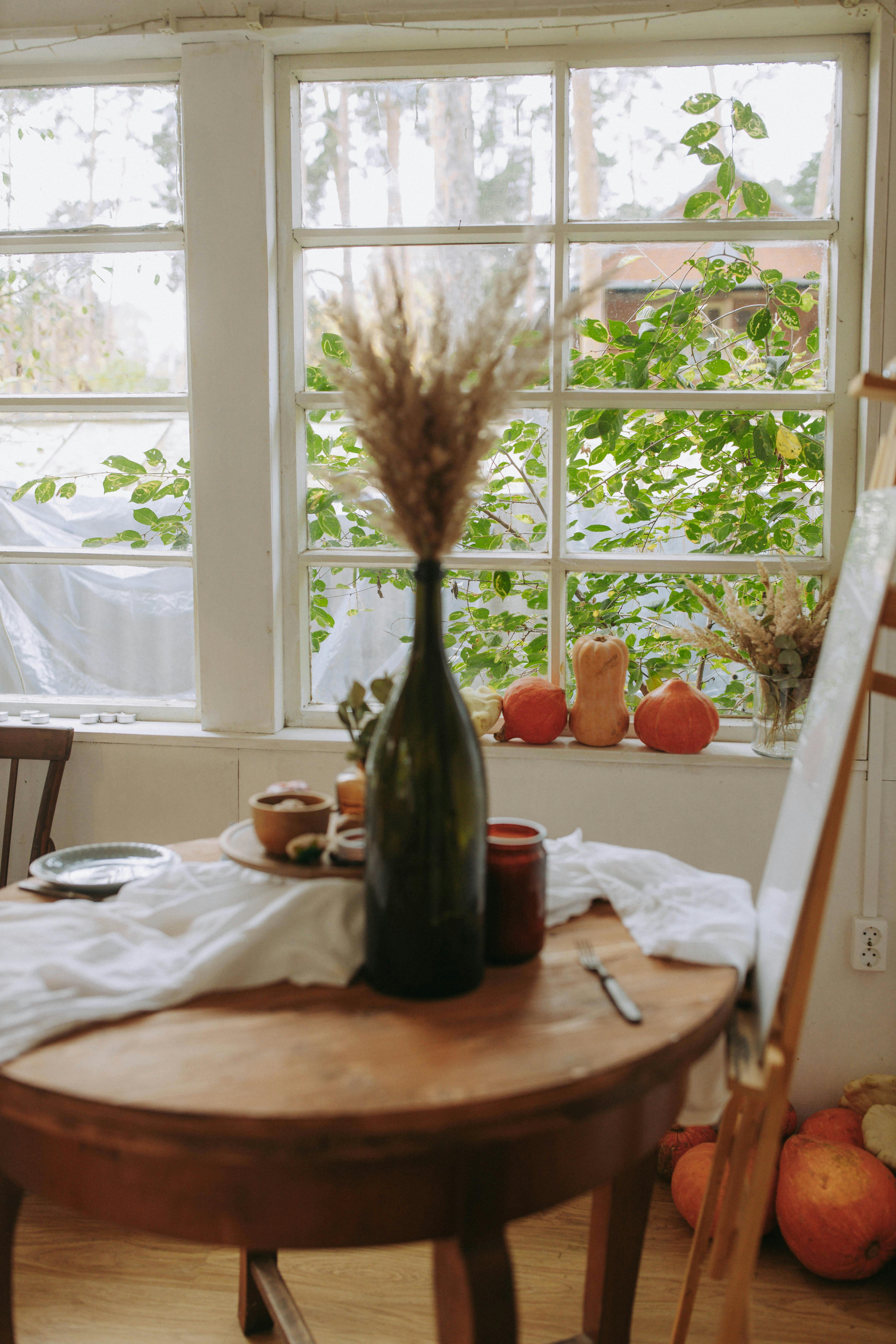 green glass bottle on brown wooden table