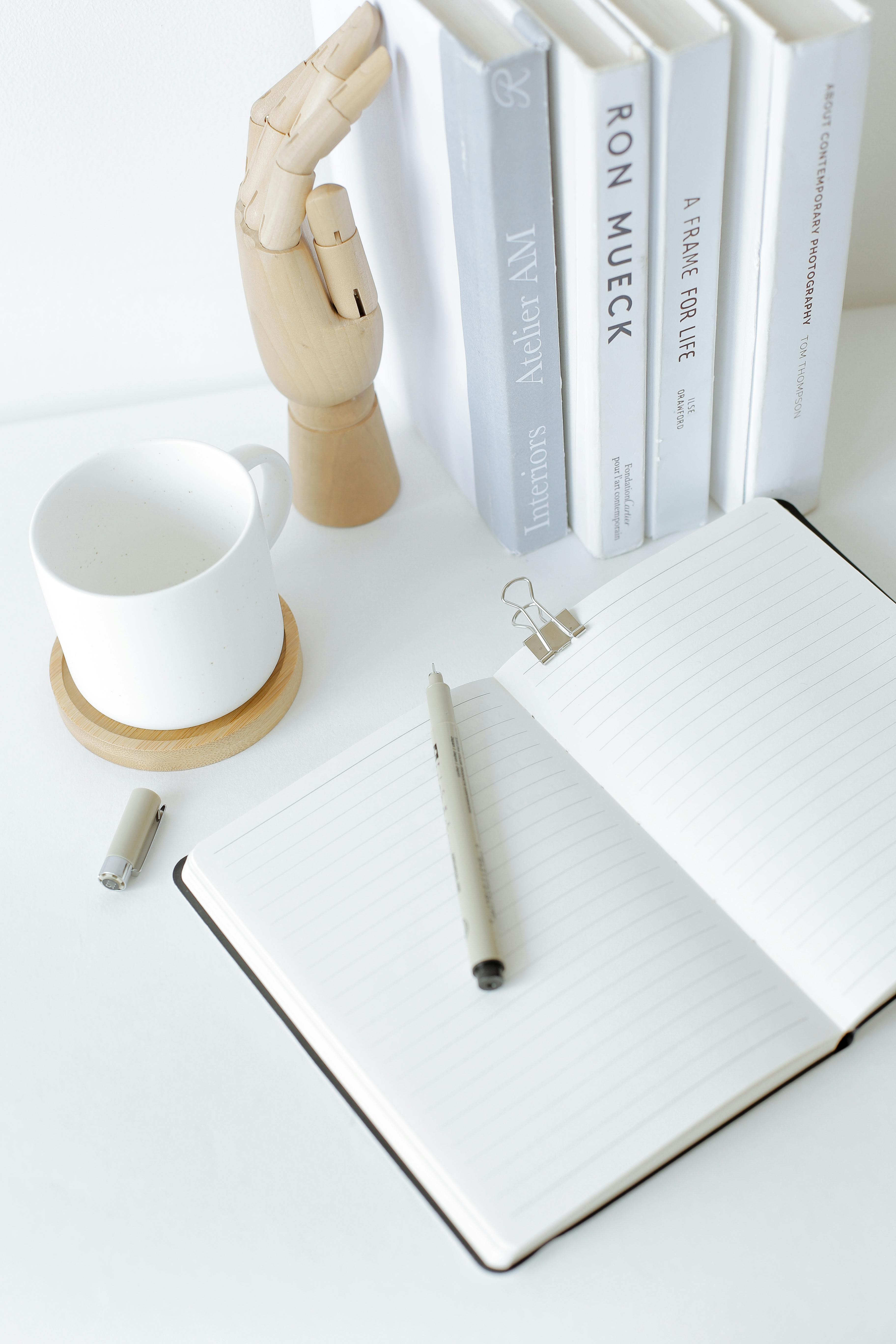 notebook opened on desk near books