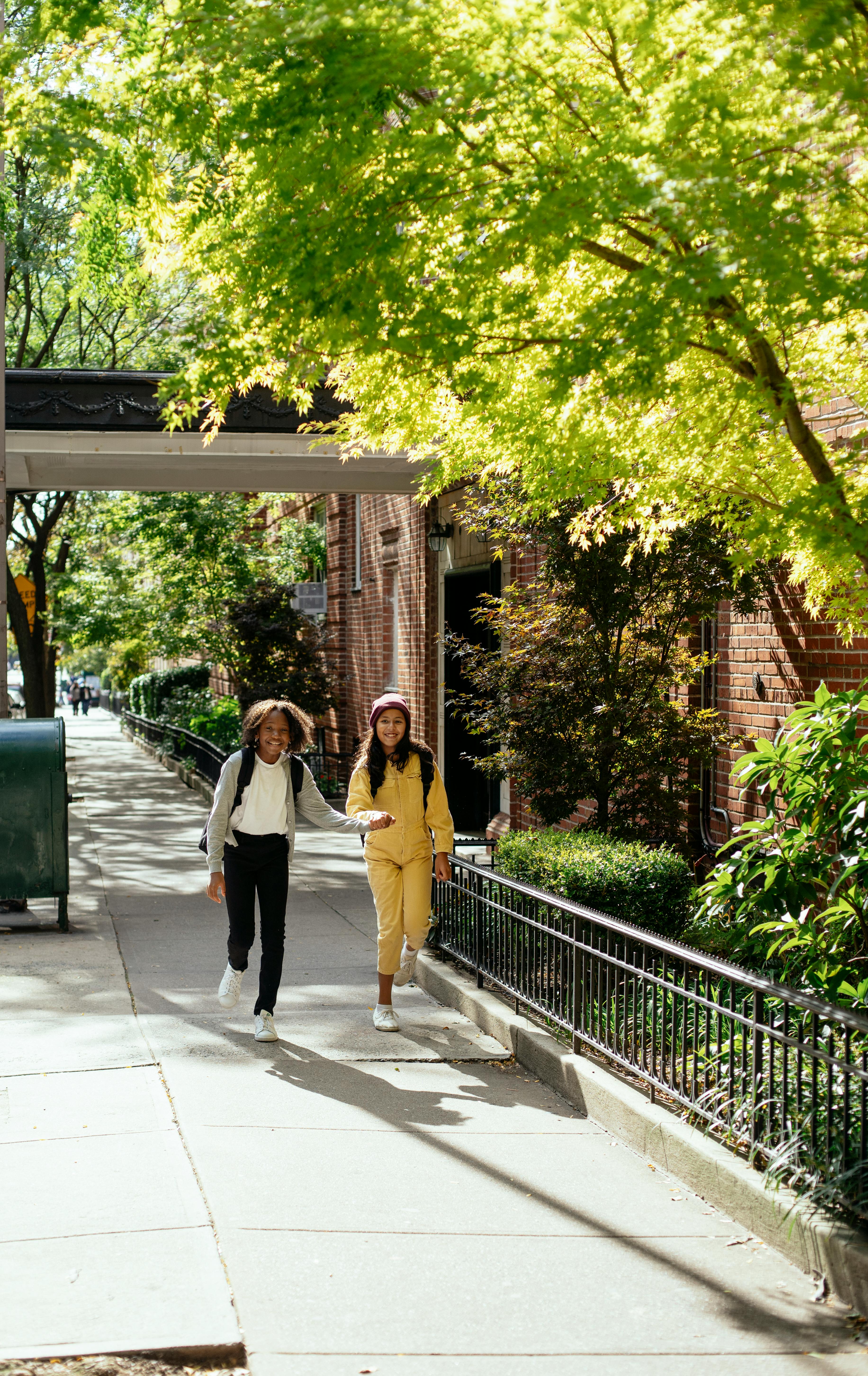 multiracial girlfriends walking on street after school