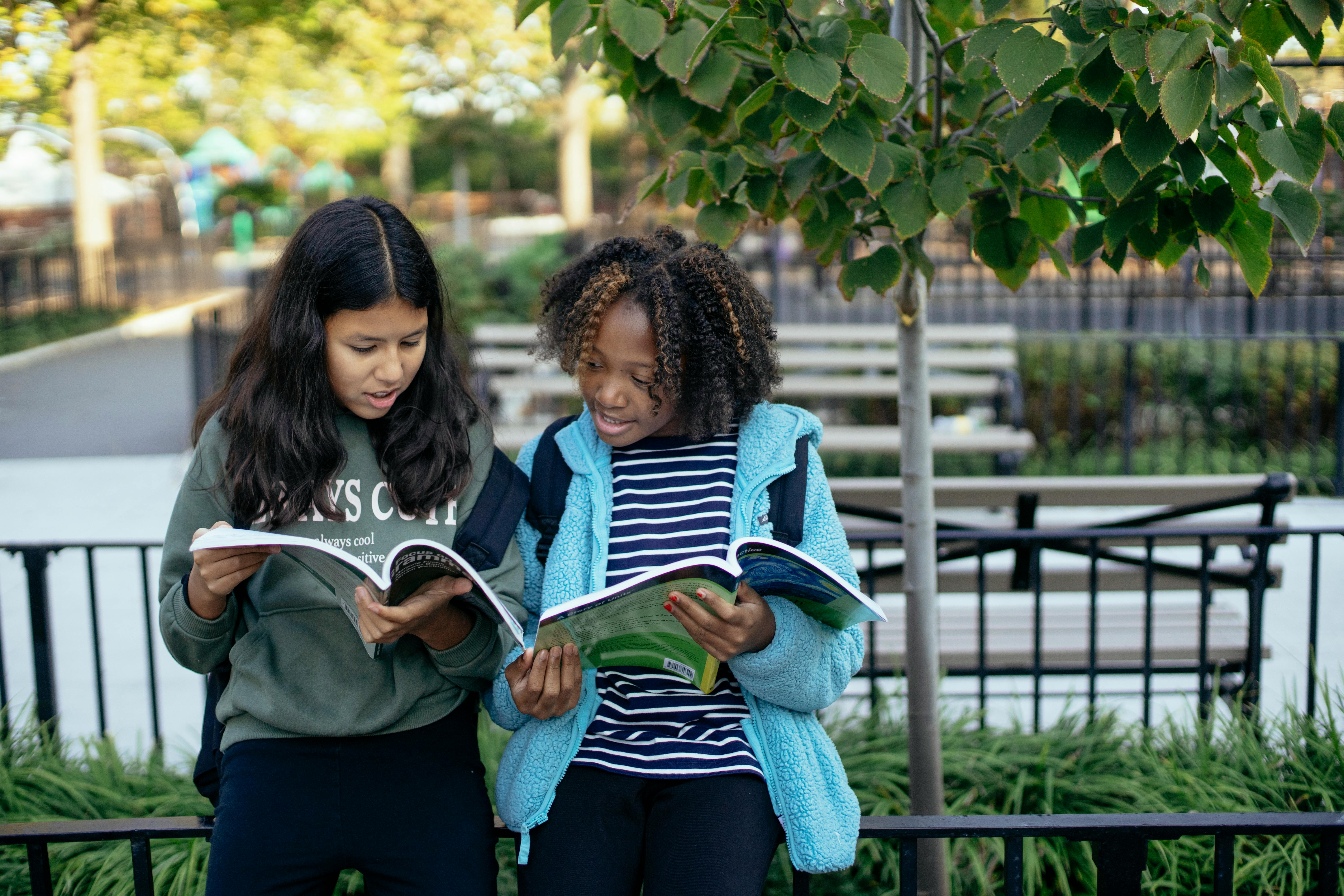 focused multiethnic schoolgirls with copybooks