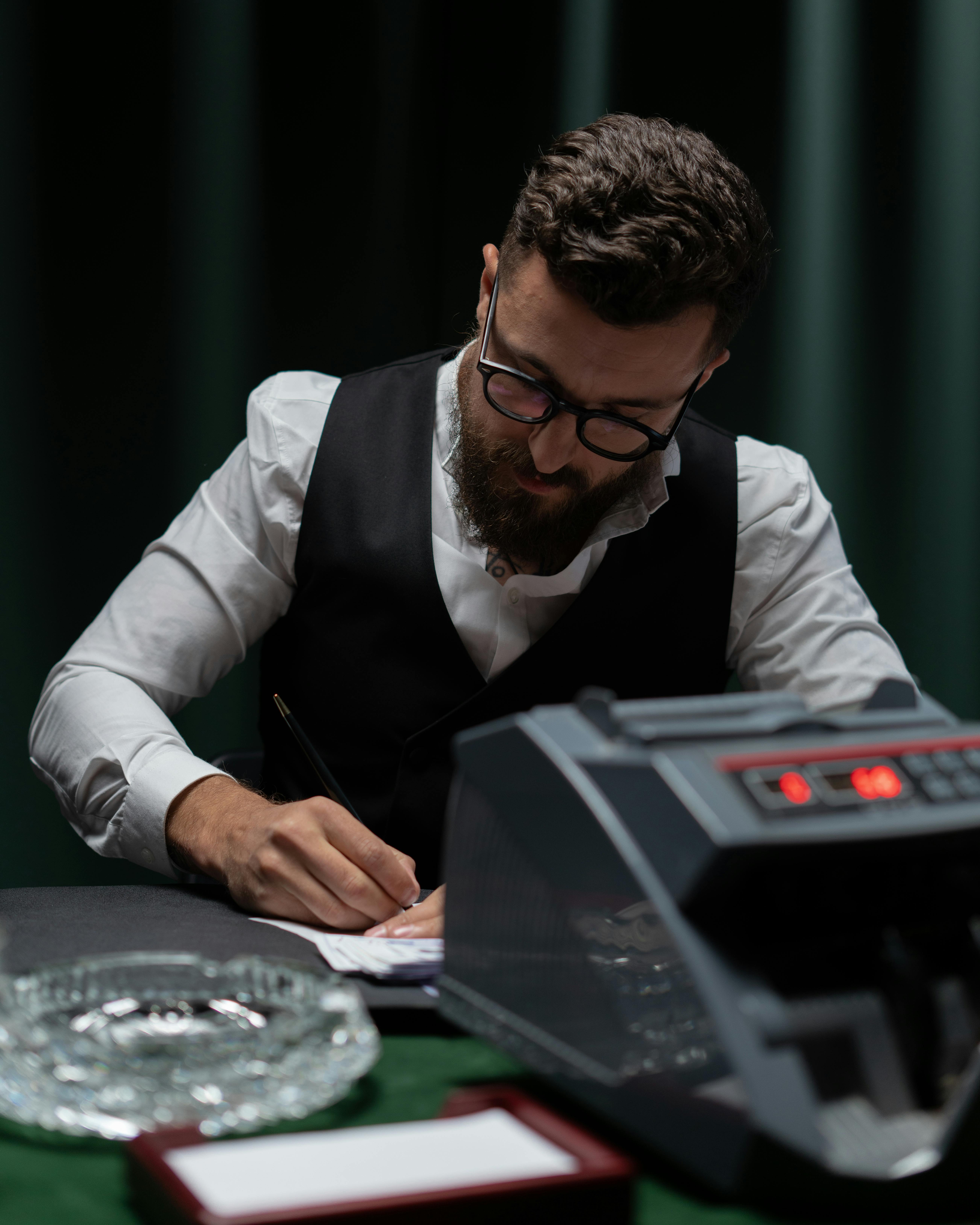 croupier in black vest counting