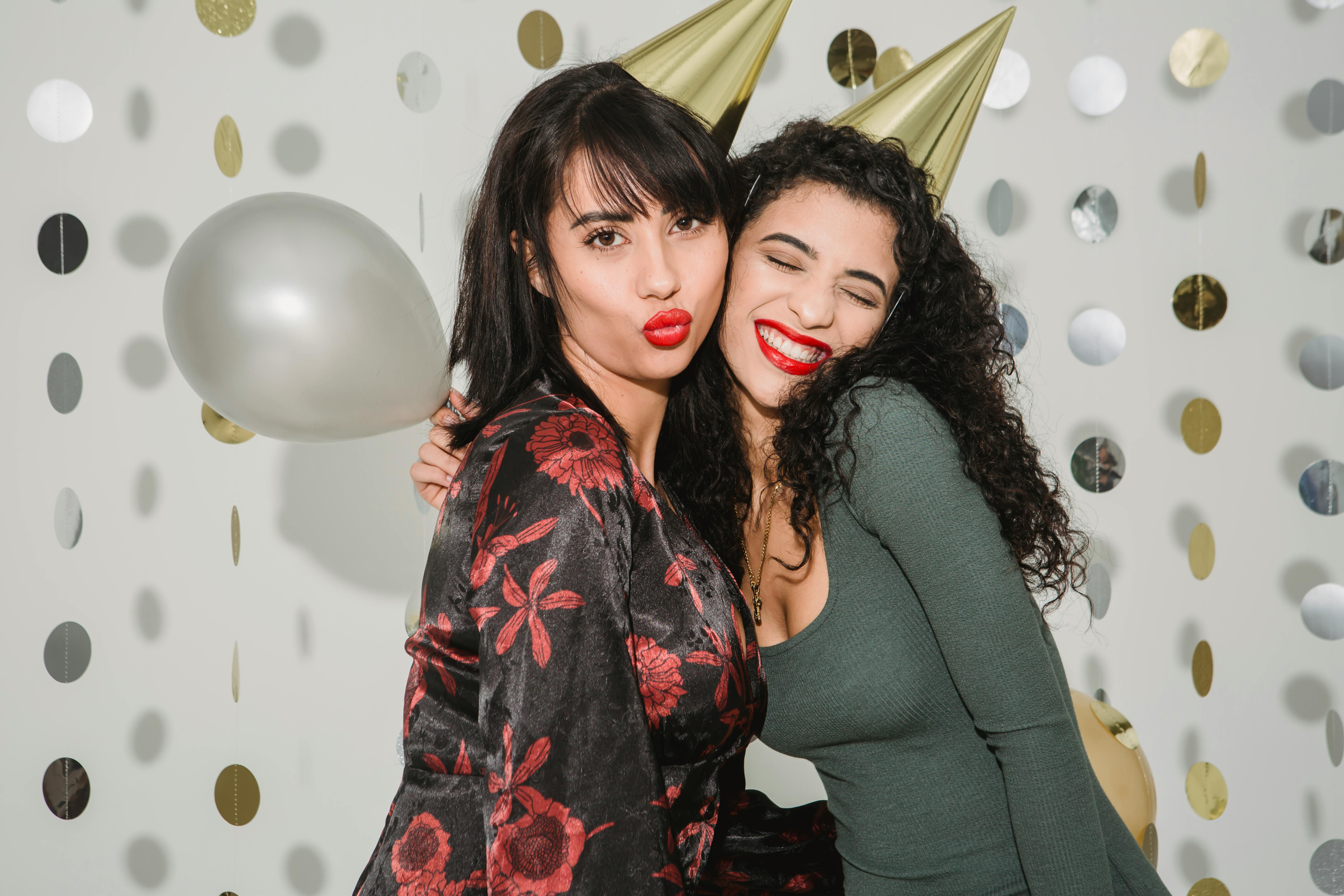 happy women hugging while celebrating holiday