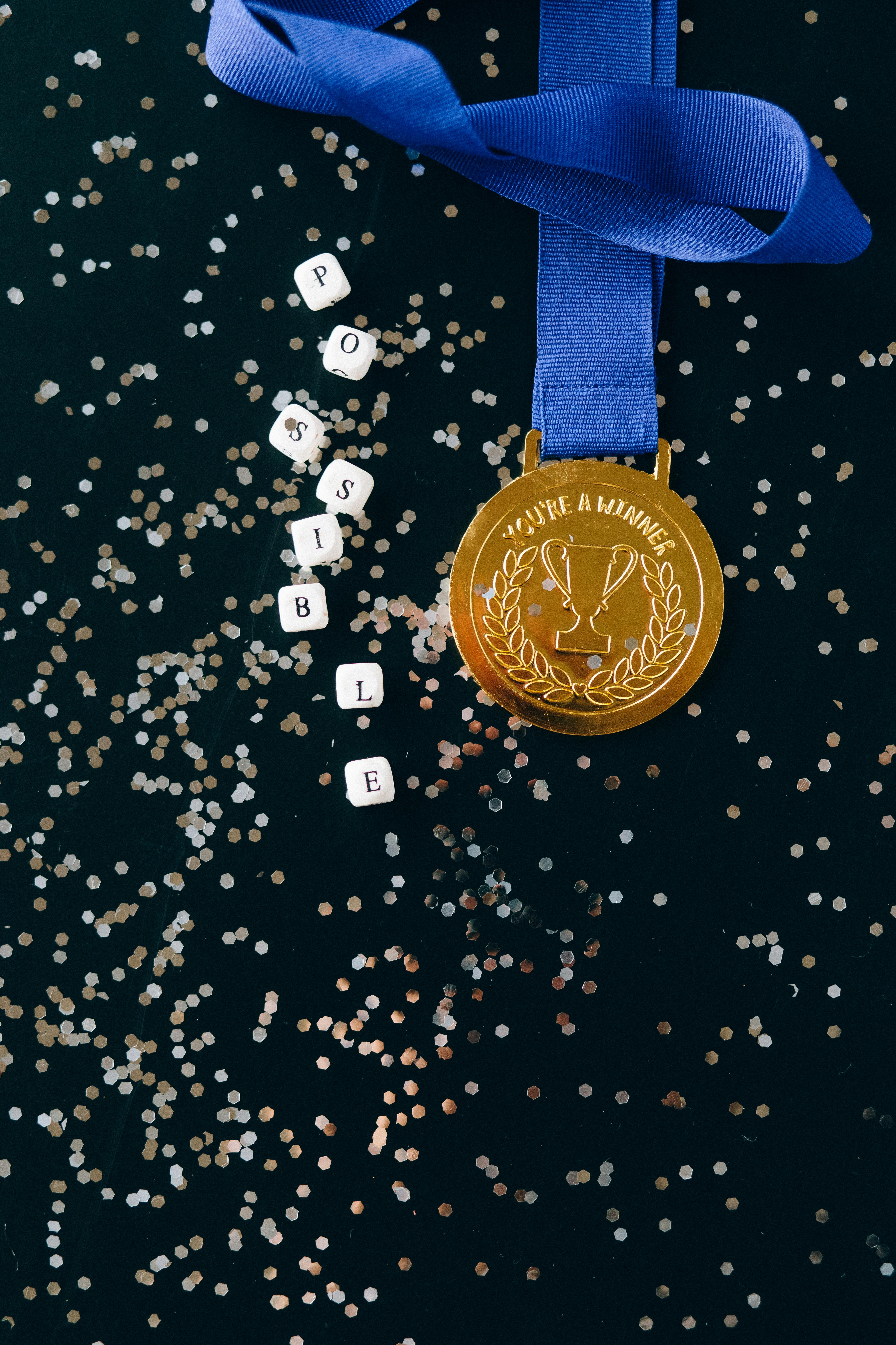 close up shot of a gold medal on a black surface