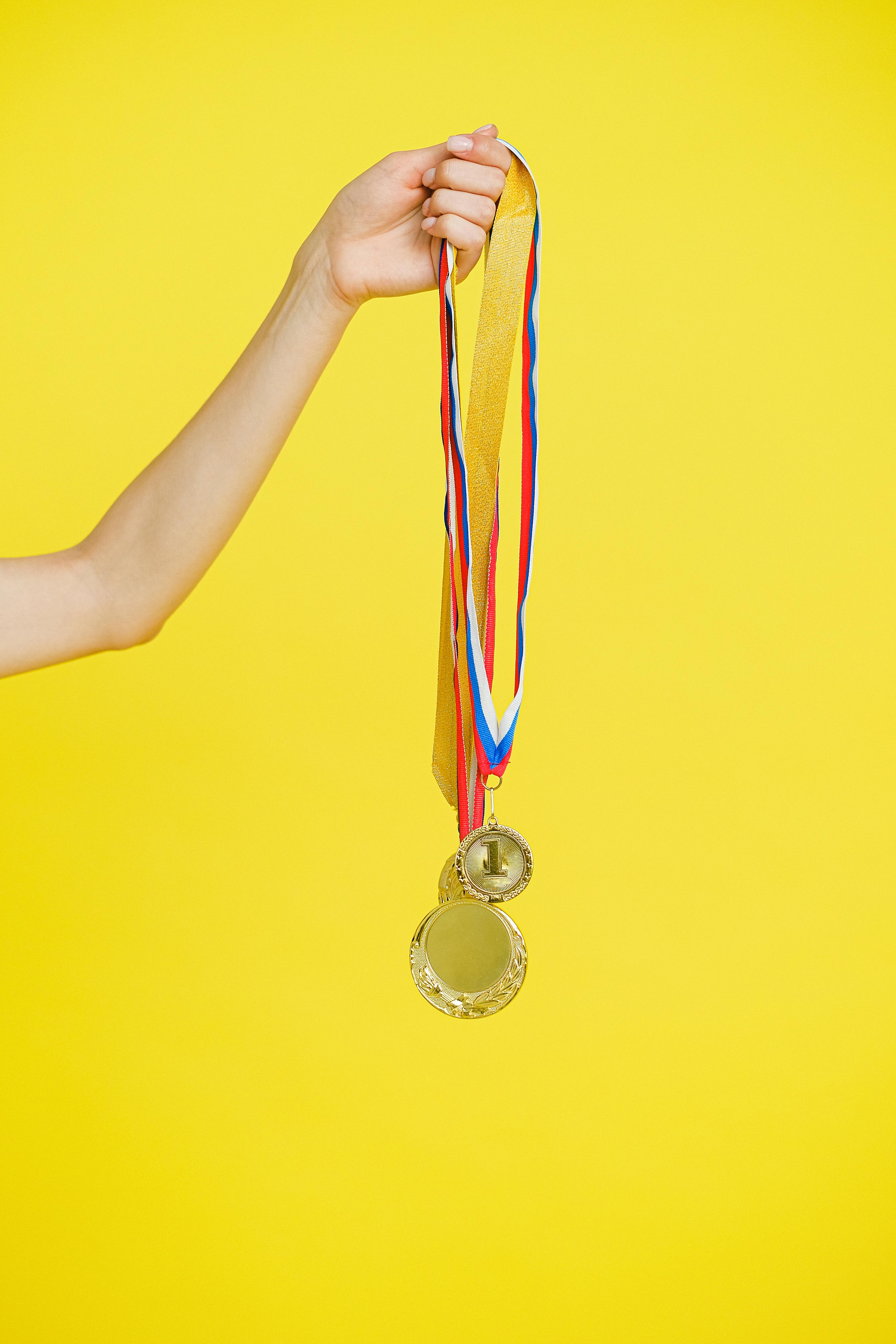 person holding medals