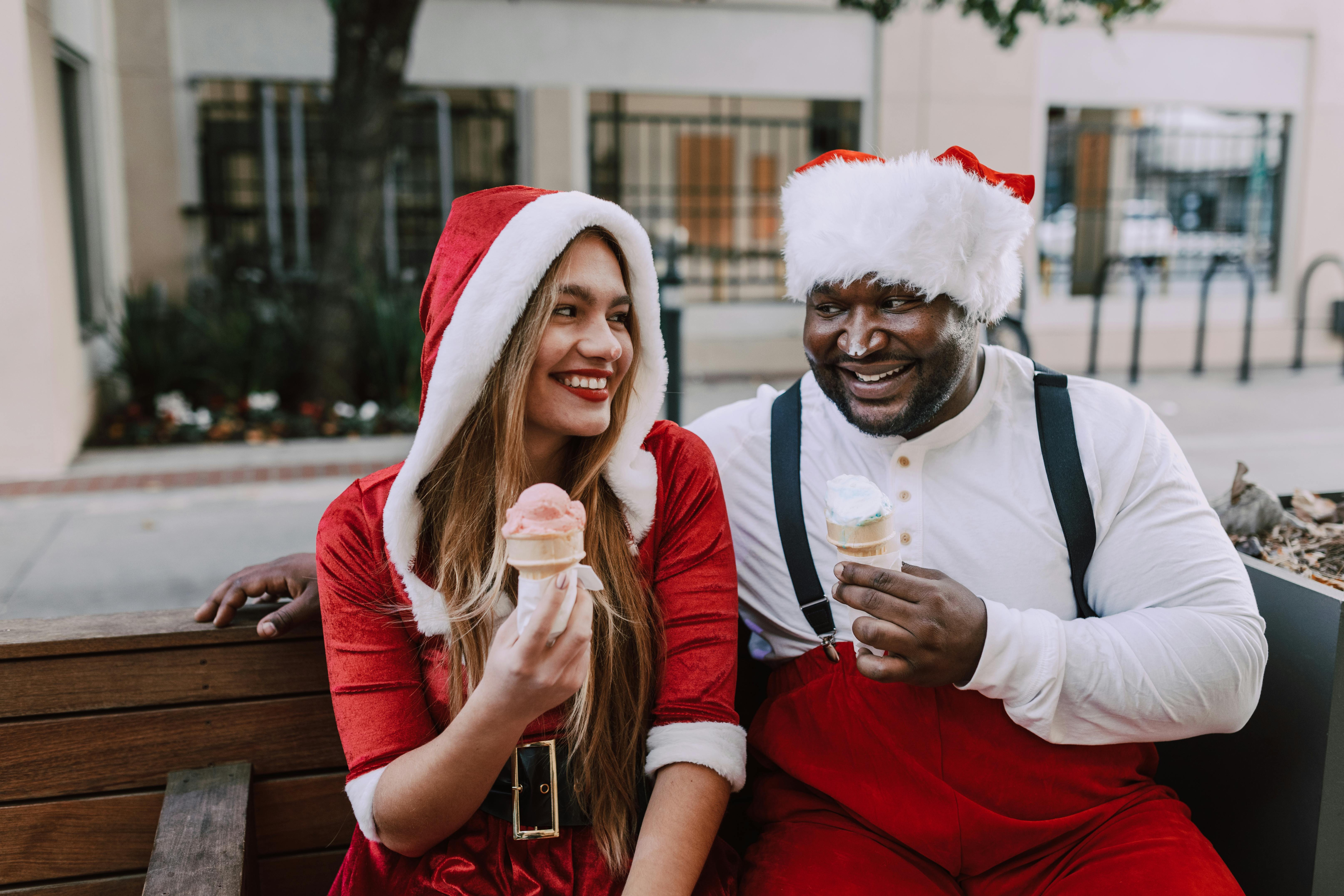 man in santa costume beside woman in red long sleeve shirt