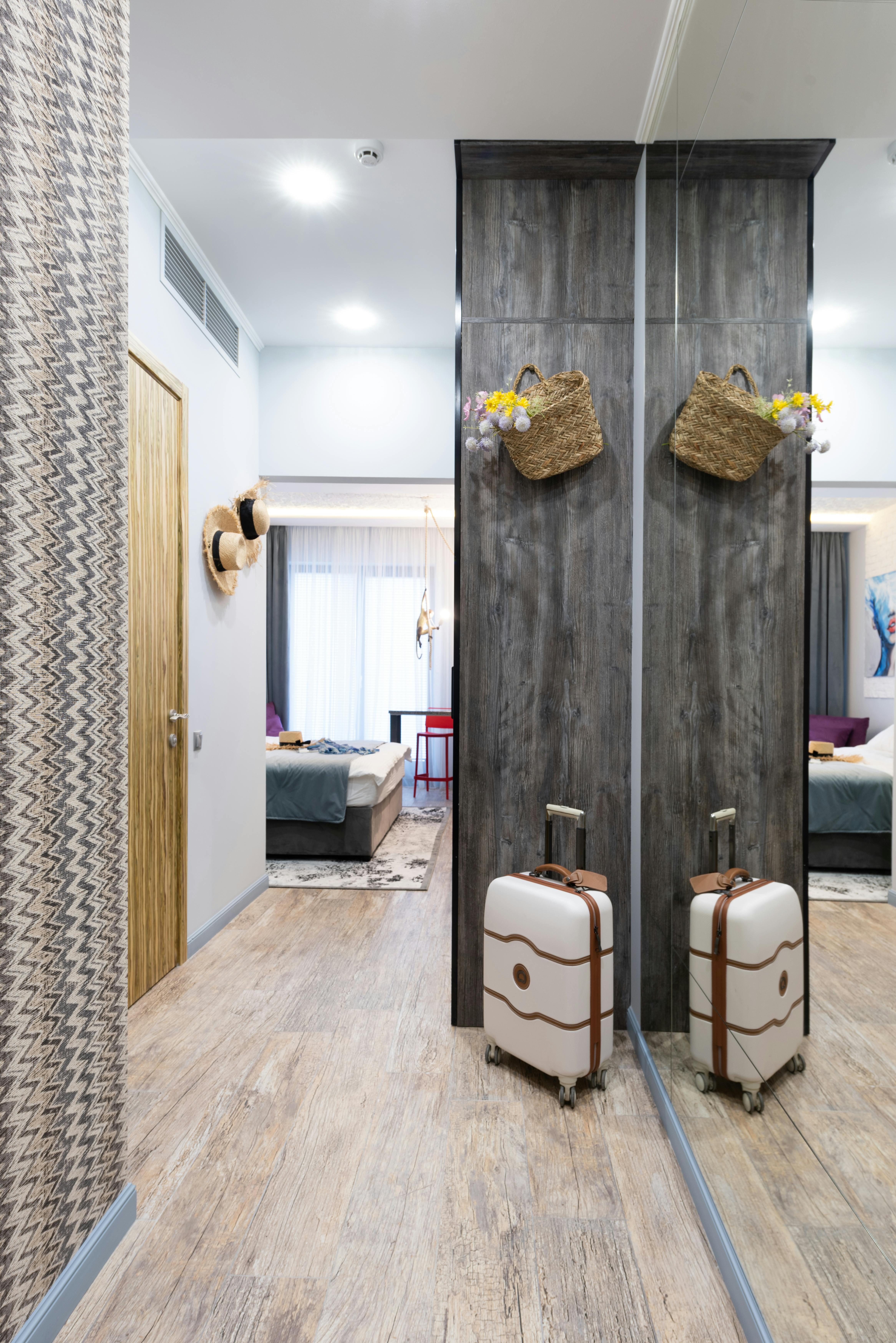 suitcase in stylish corridor near mirror