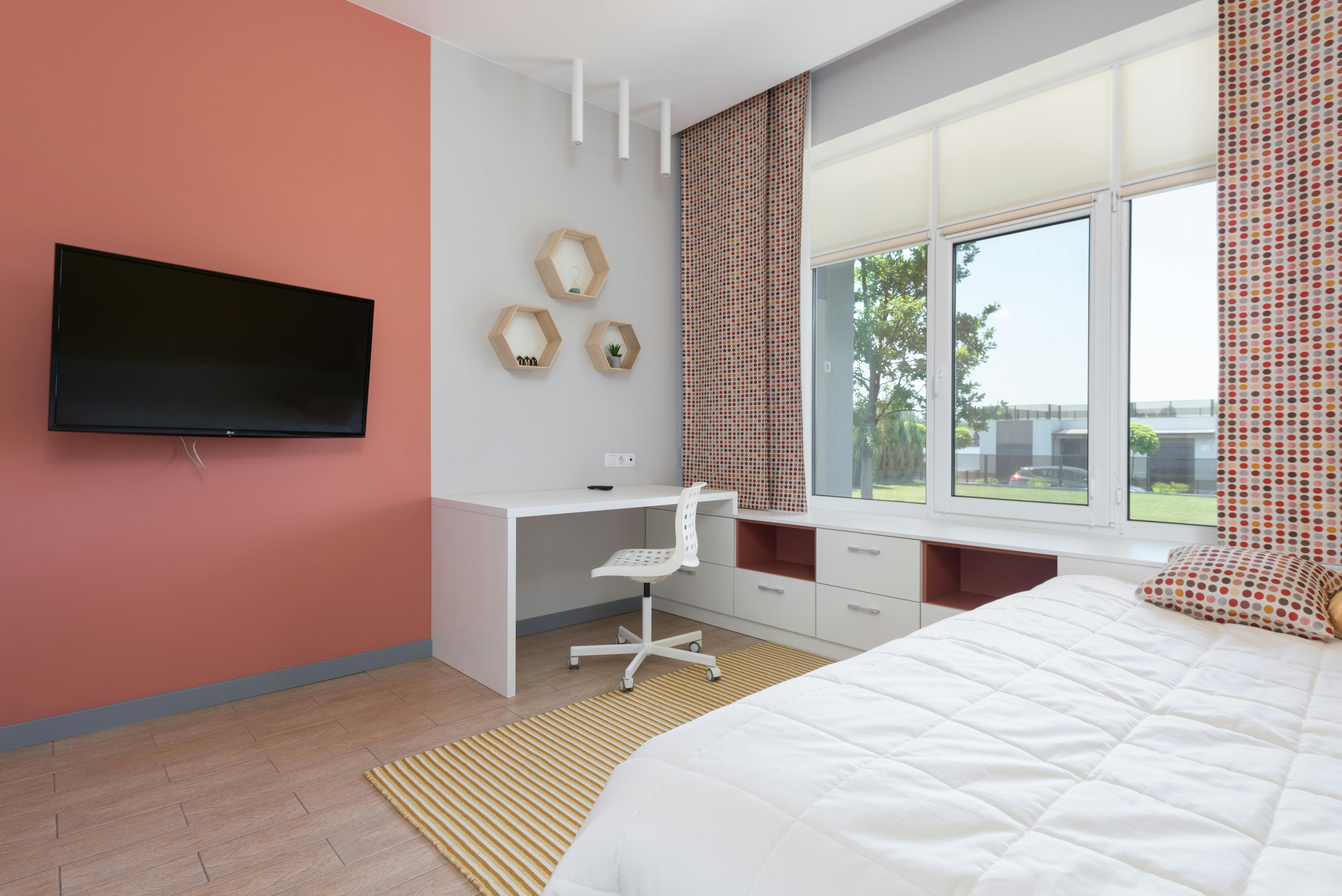 stylish interior of spacious bedroom in red tones