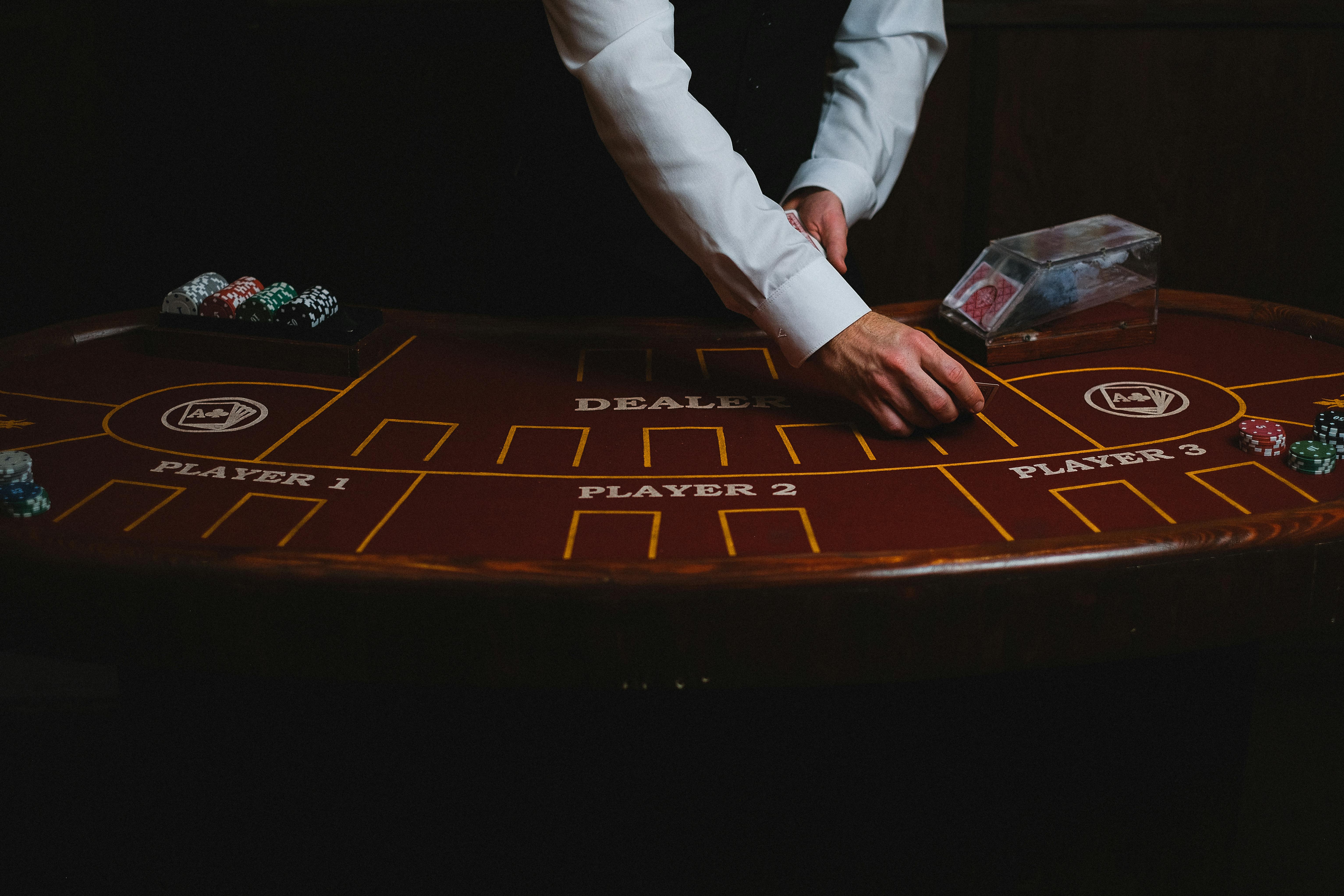 close up of blackjack table and croupier hands