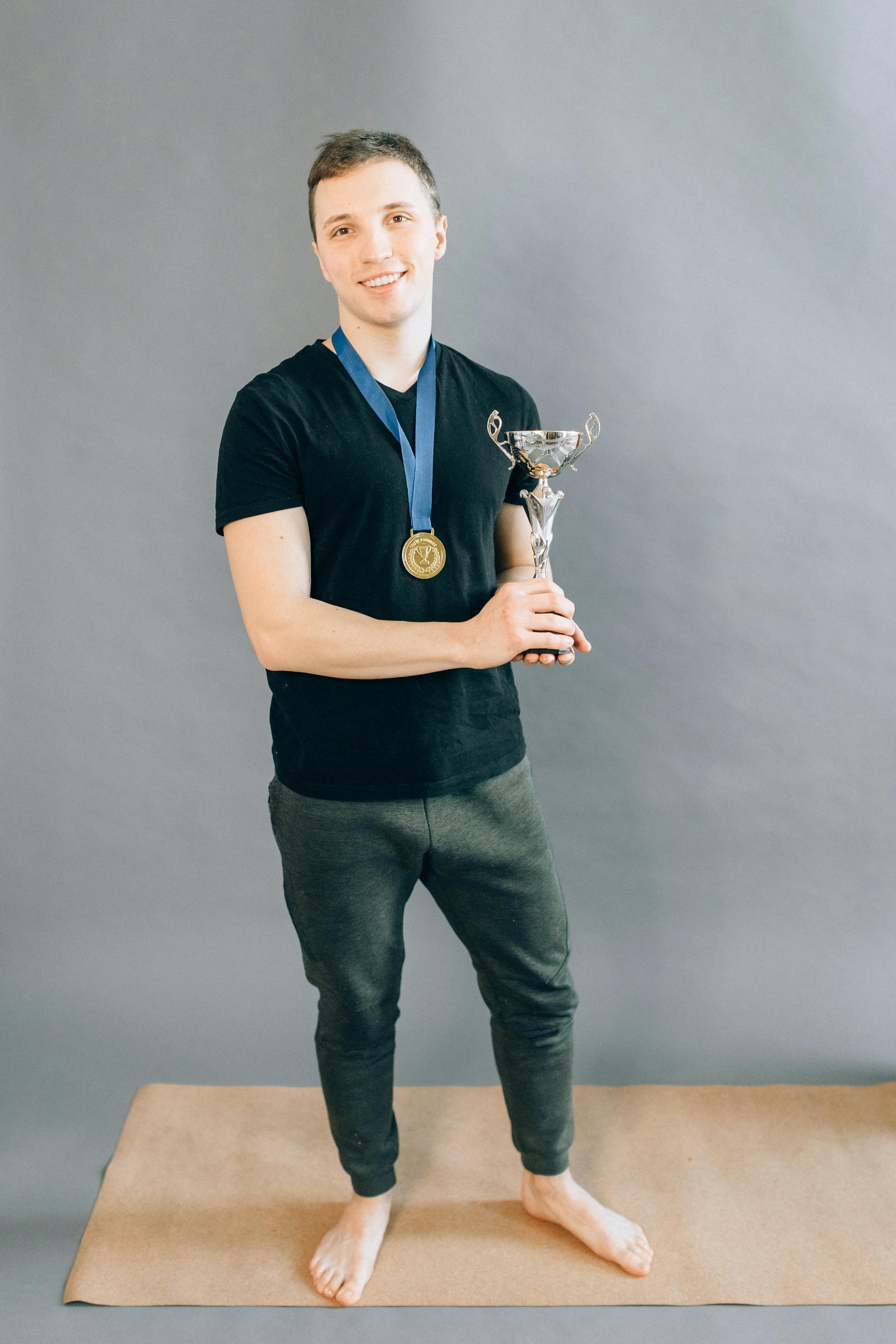 man in black shirt holding a trophy