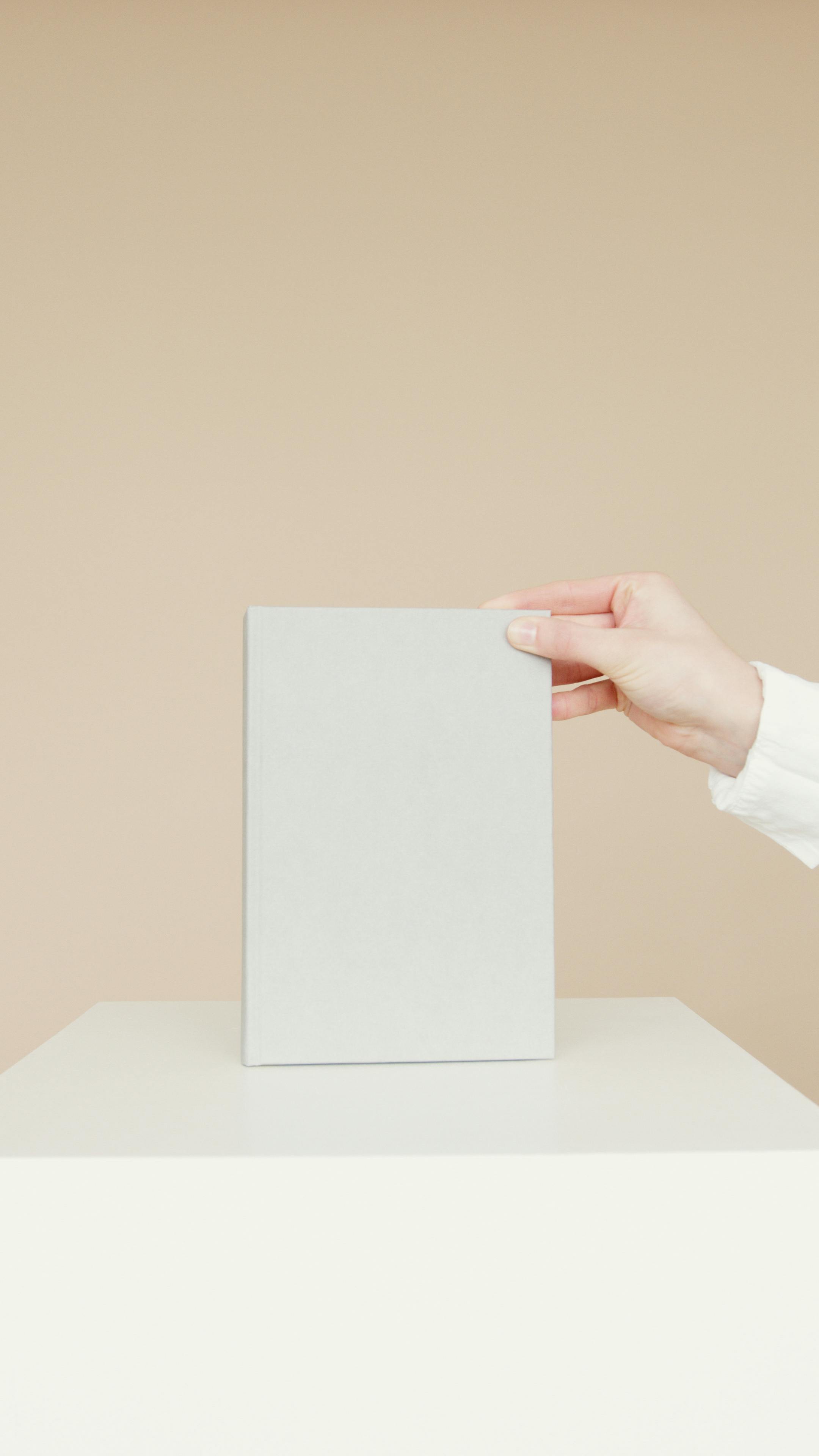 person holding white printer paper