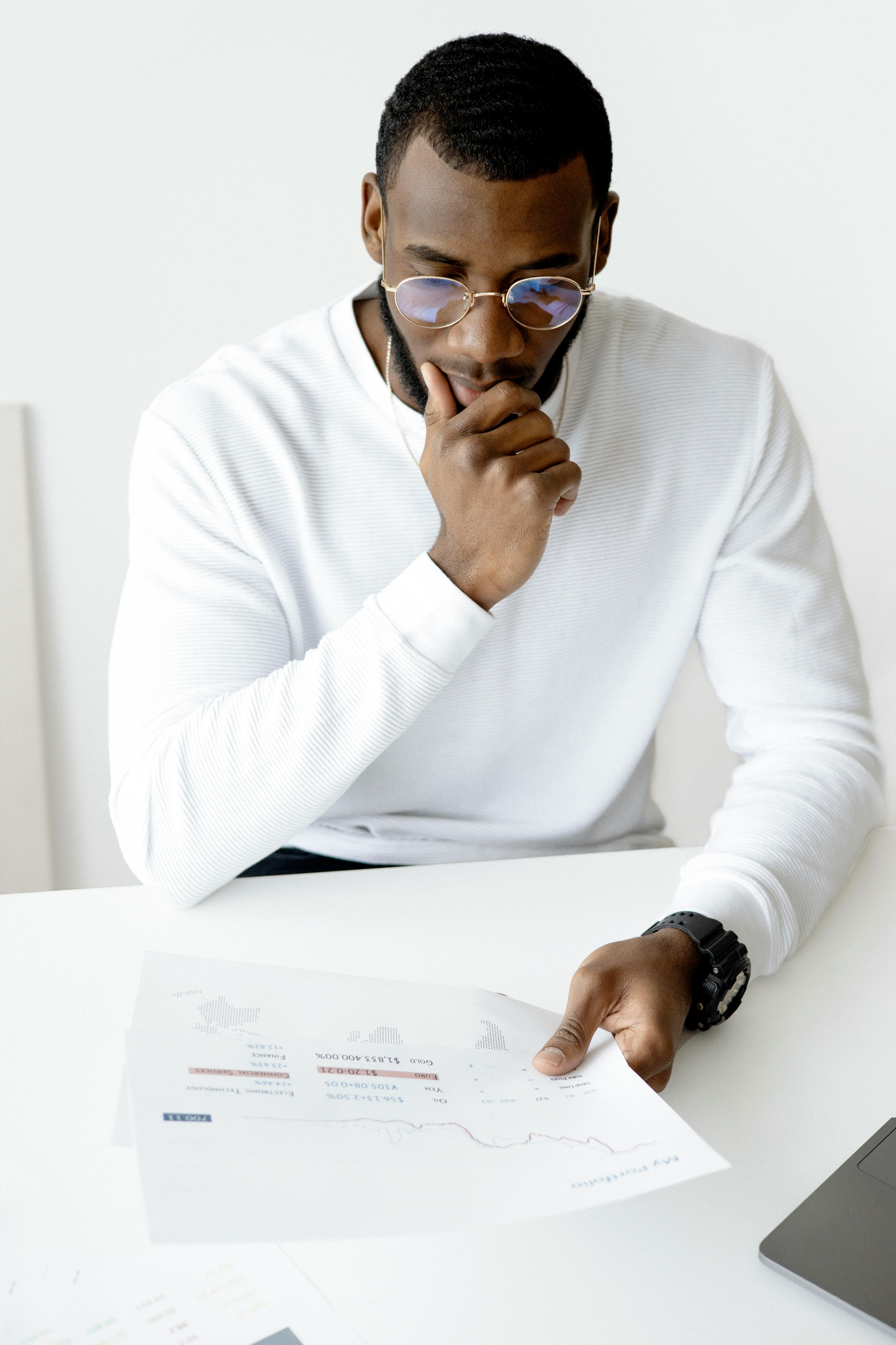 photo of man holding white paper