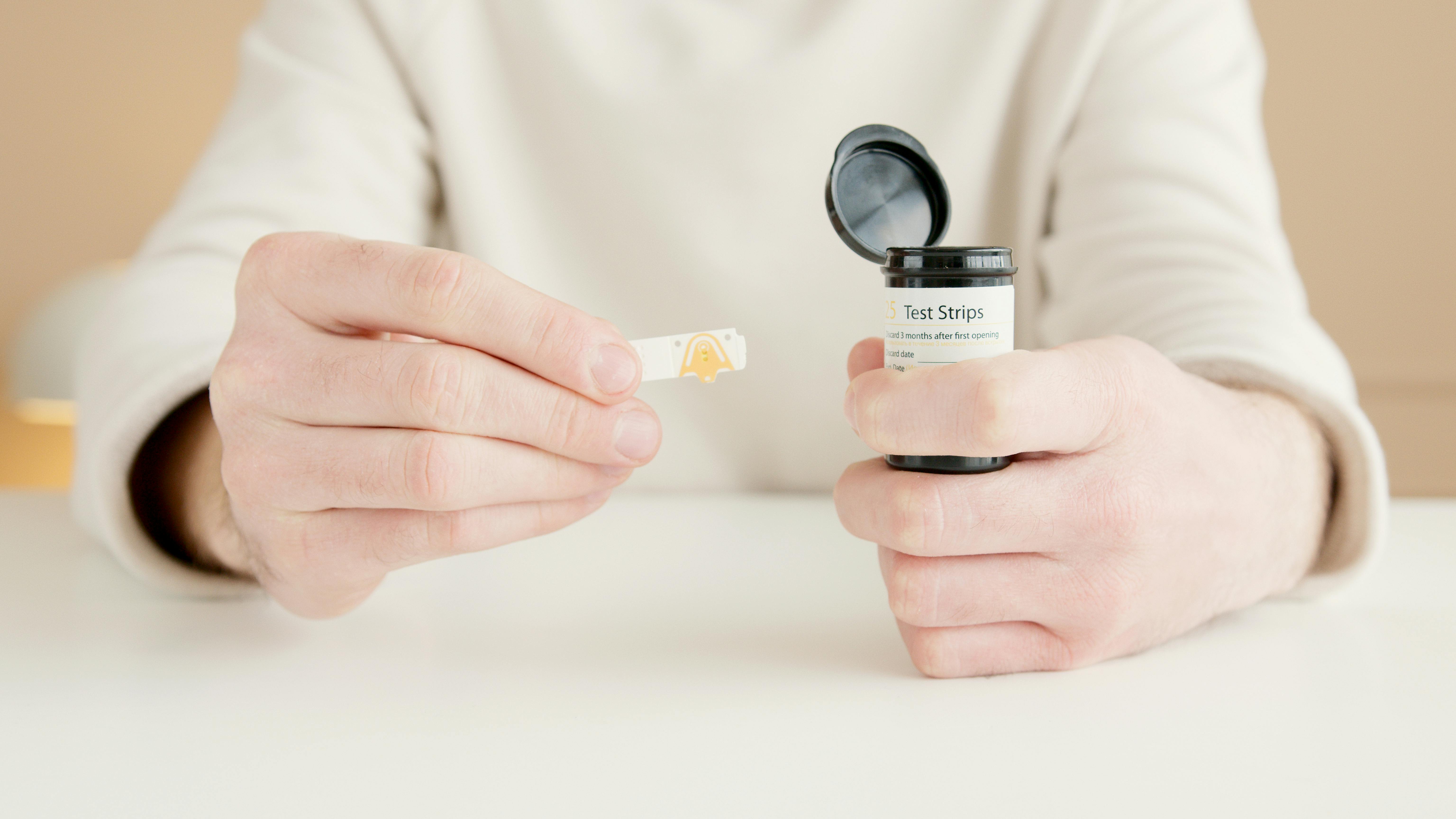 a person holding a test strip