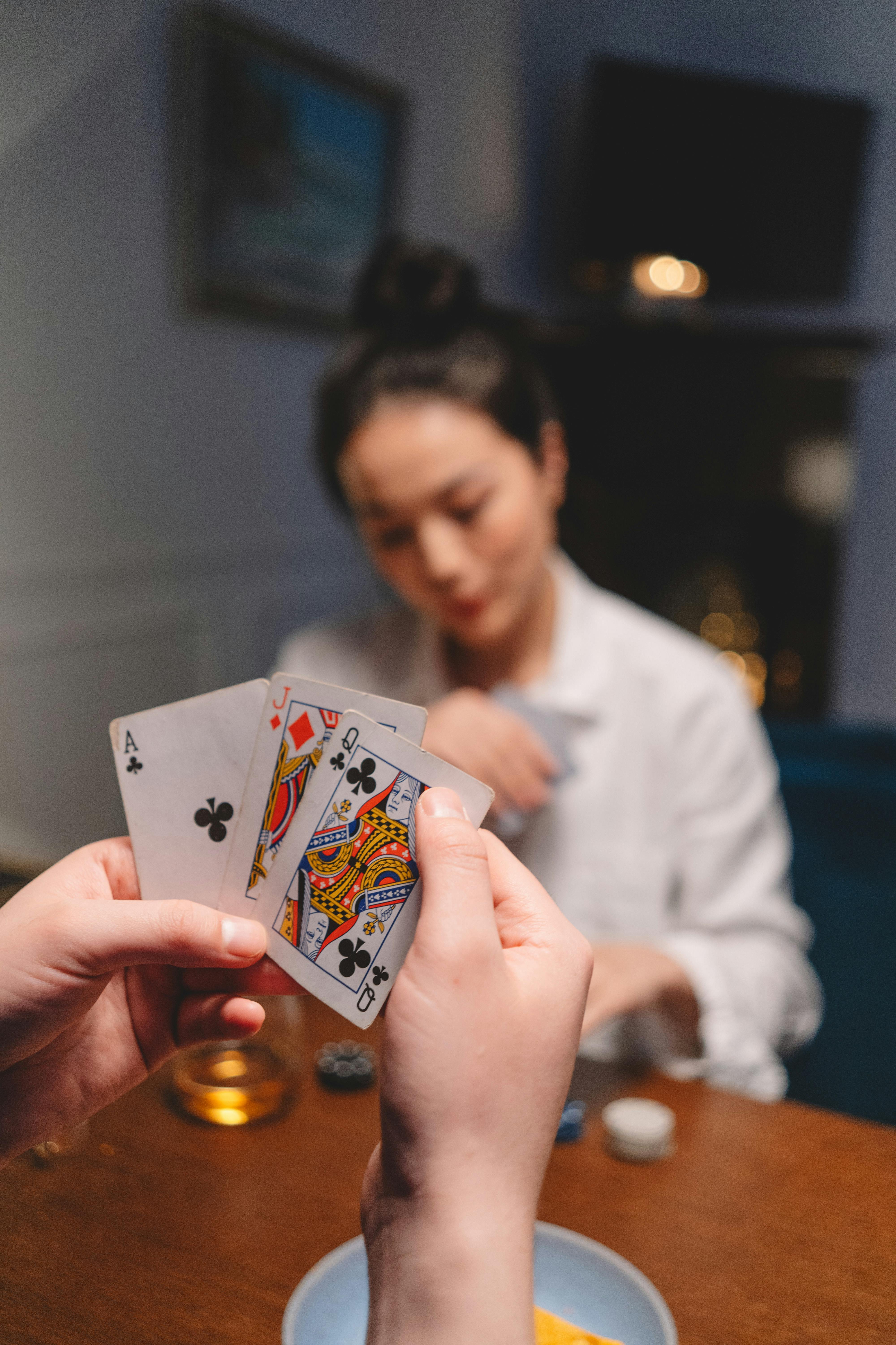 a person holding playing cards