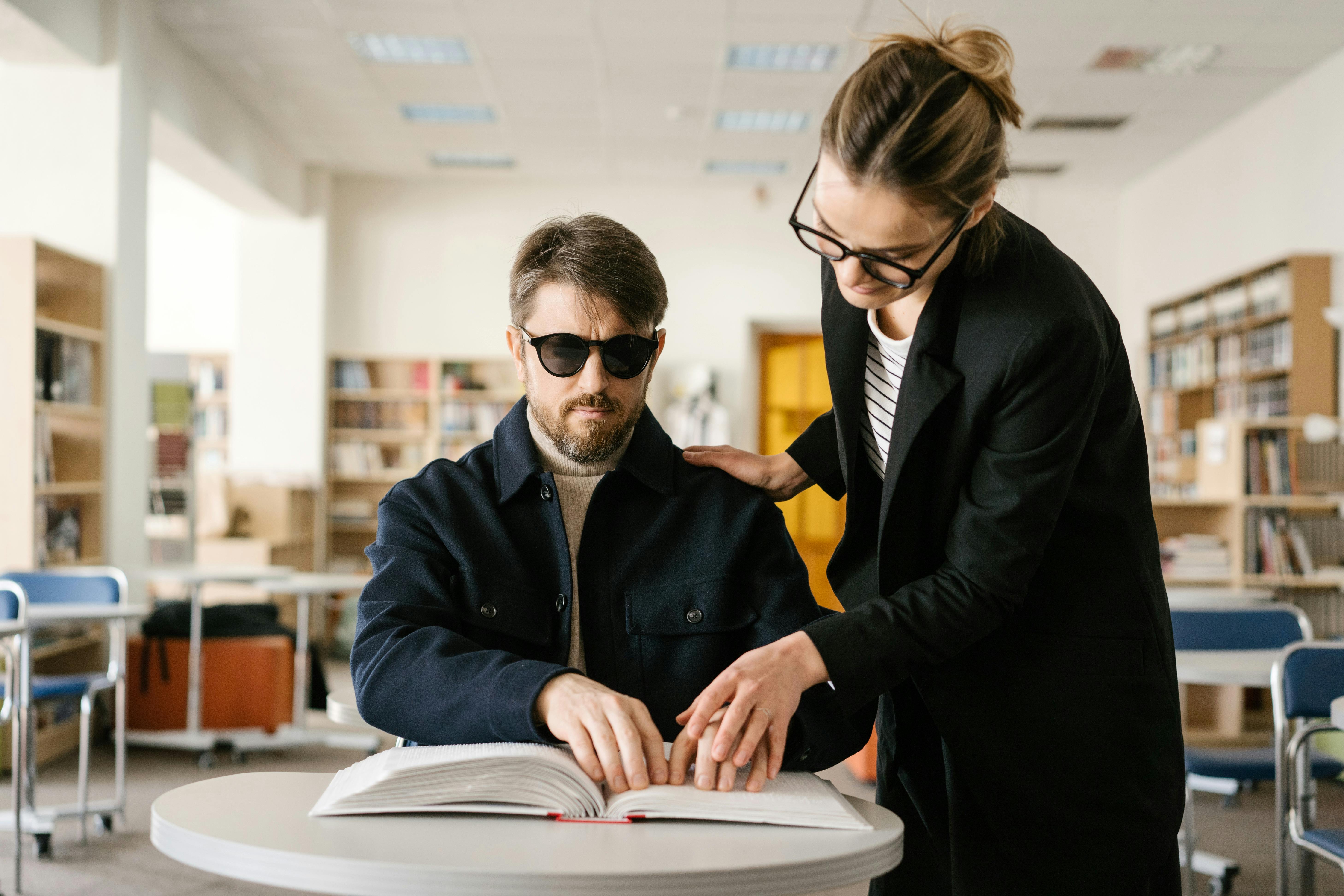 man in black jacket wearing black sunglasses with a woman