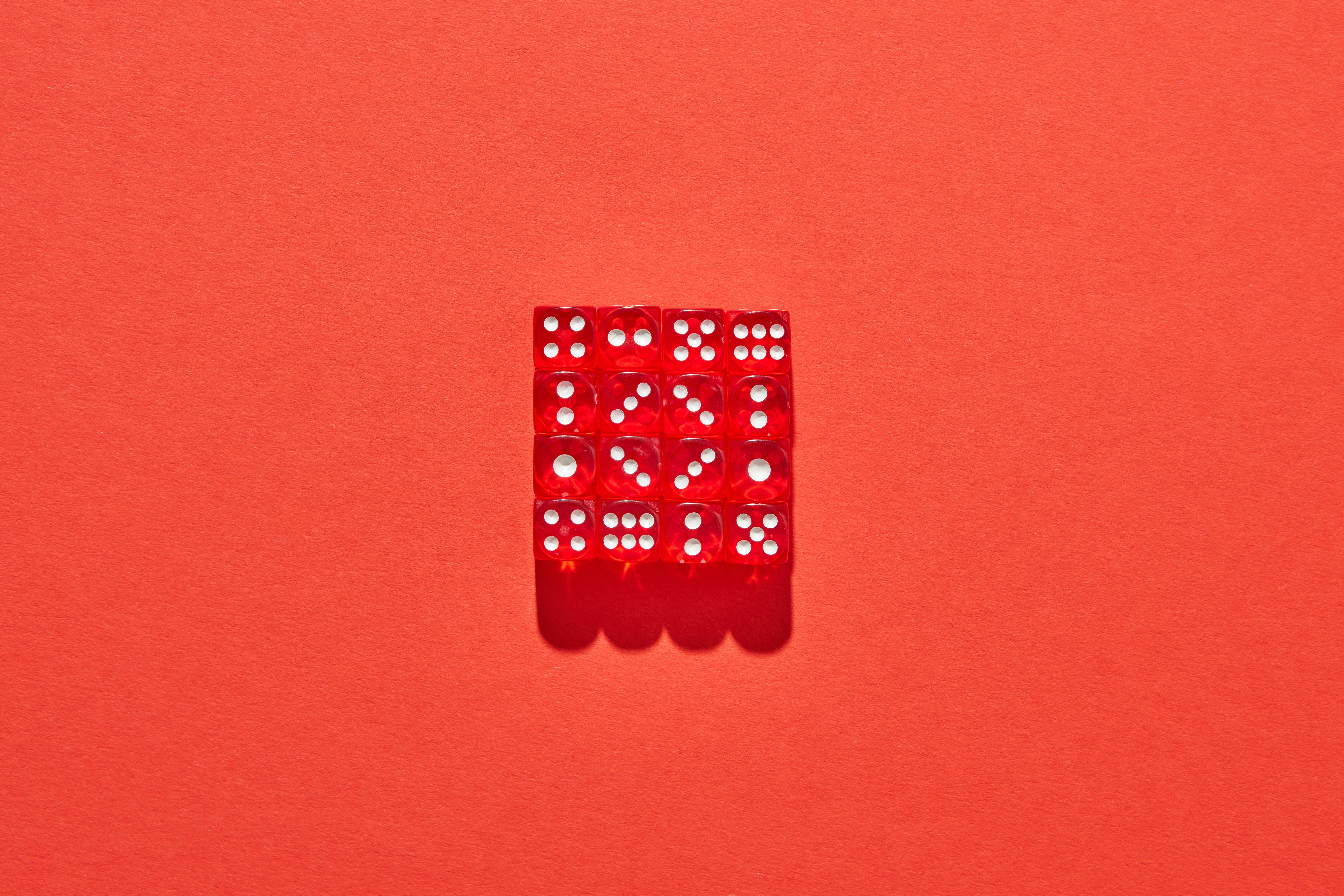 cube with dots on red surface