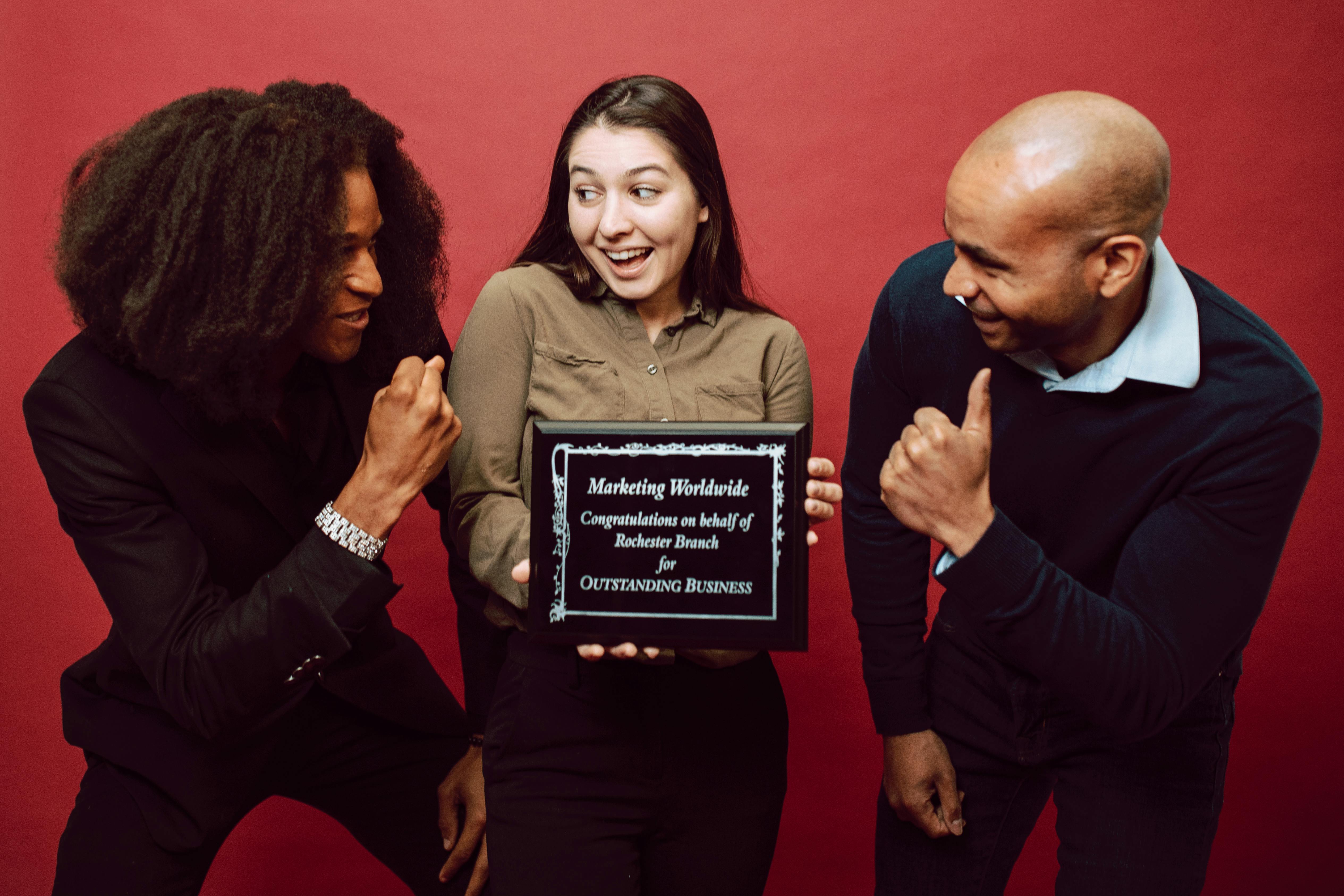 a woman holding a recognition award