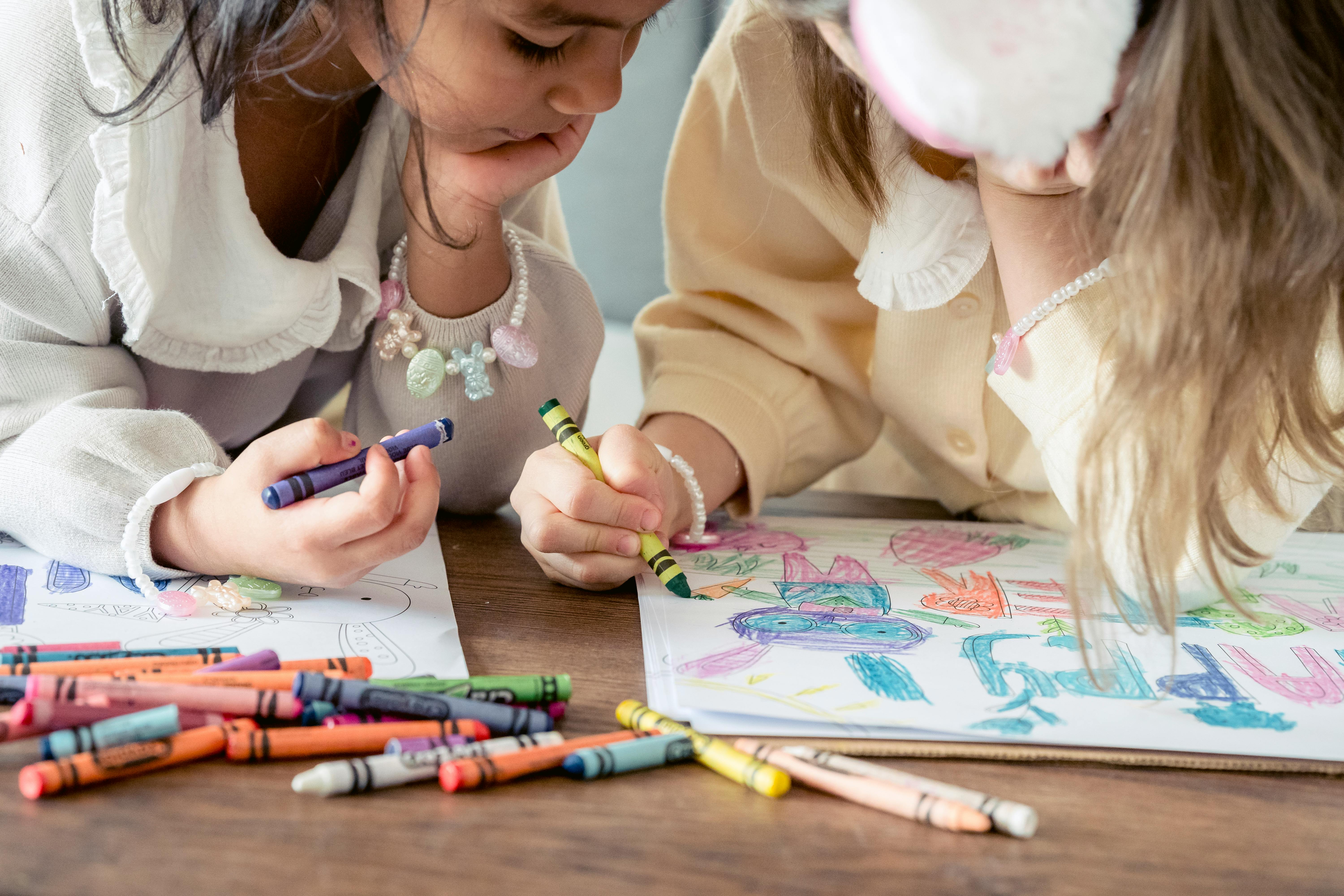 diverse girls with crayons coloring drawing for easter