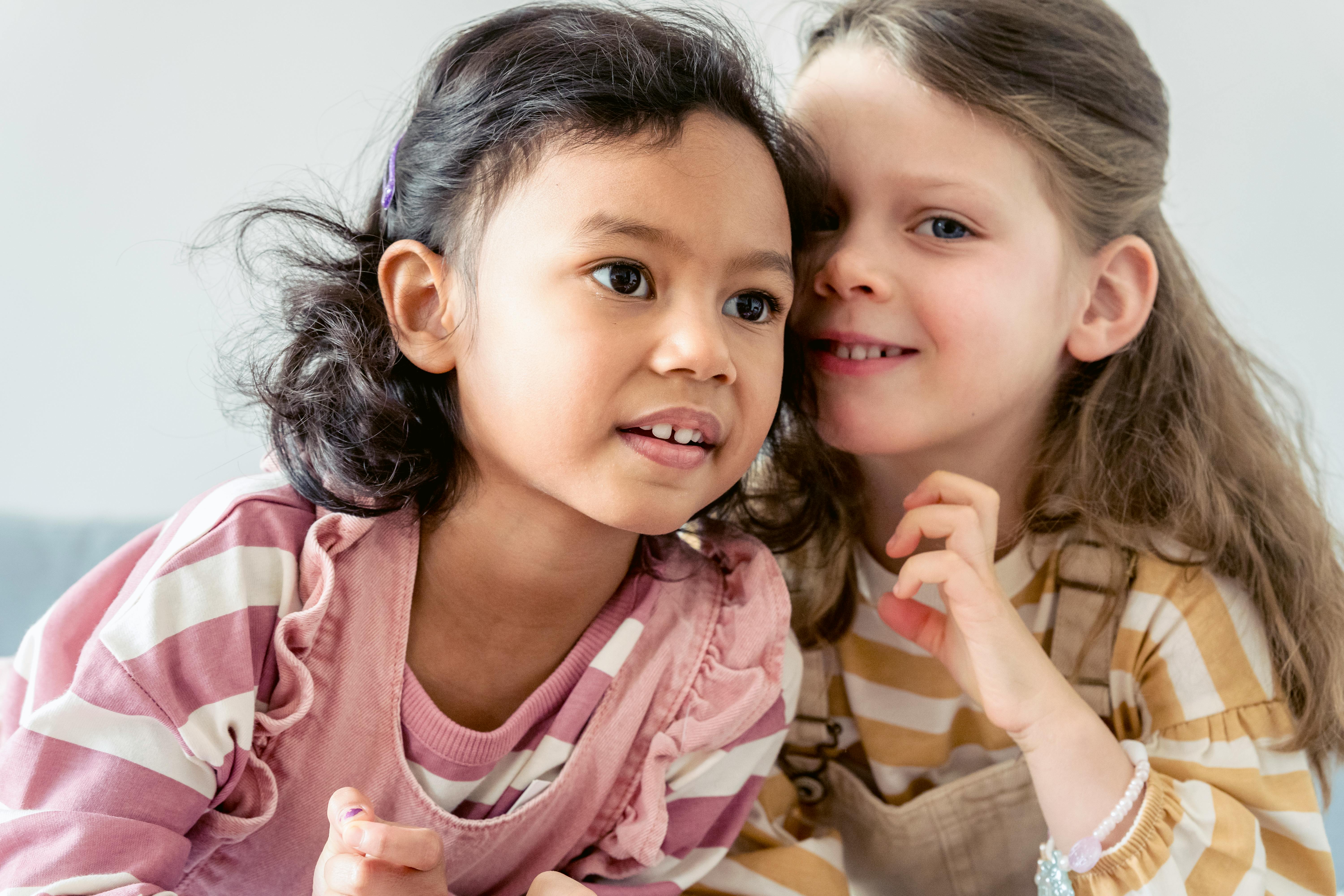 cute little girls smiling gently together