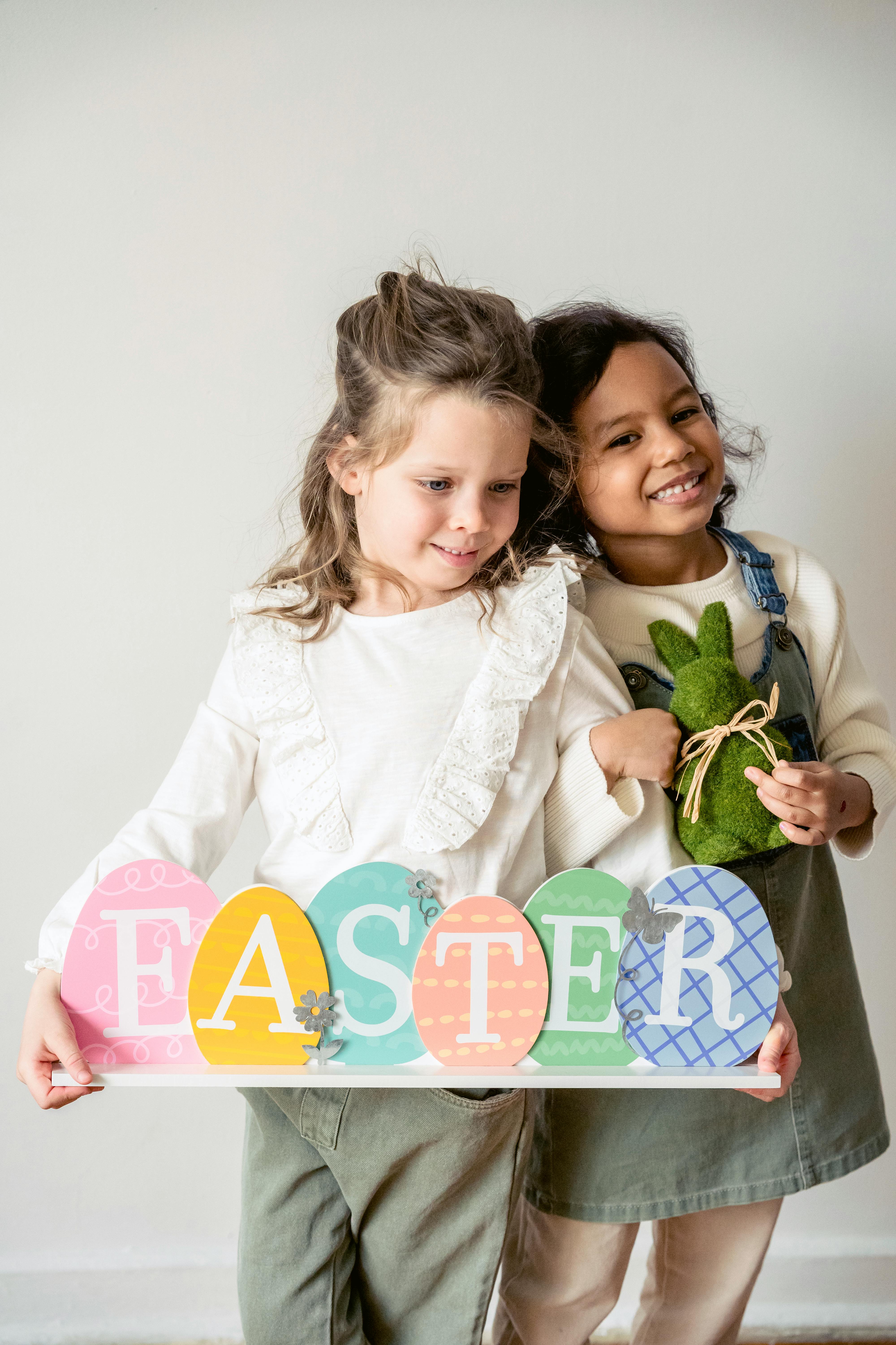 cute diverse girls with festive decorations during easter holiday