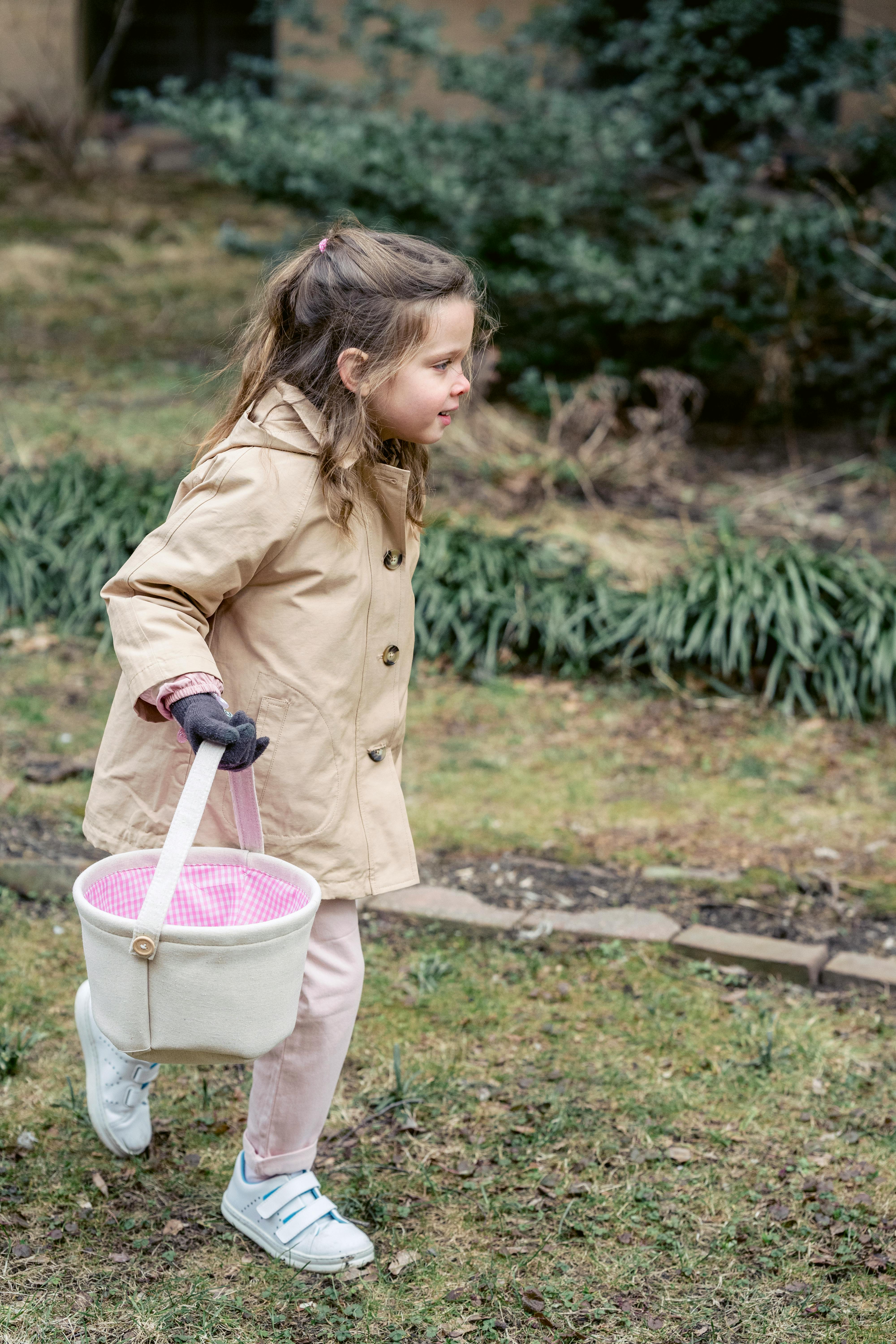 girl hunting easter eggs in garden