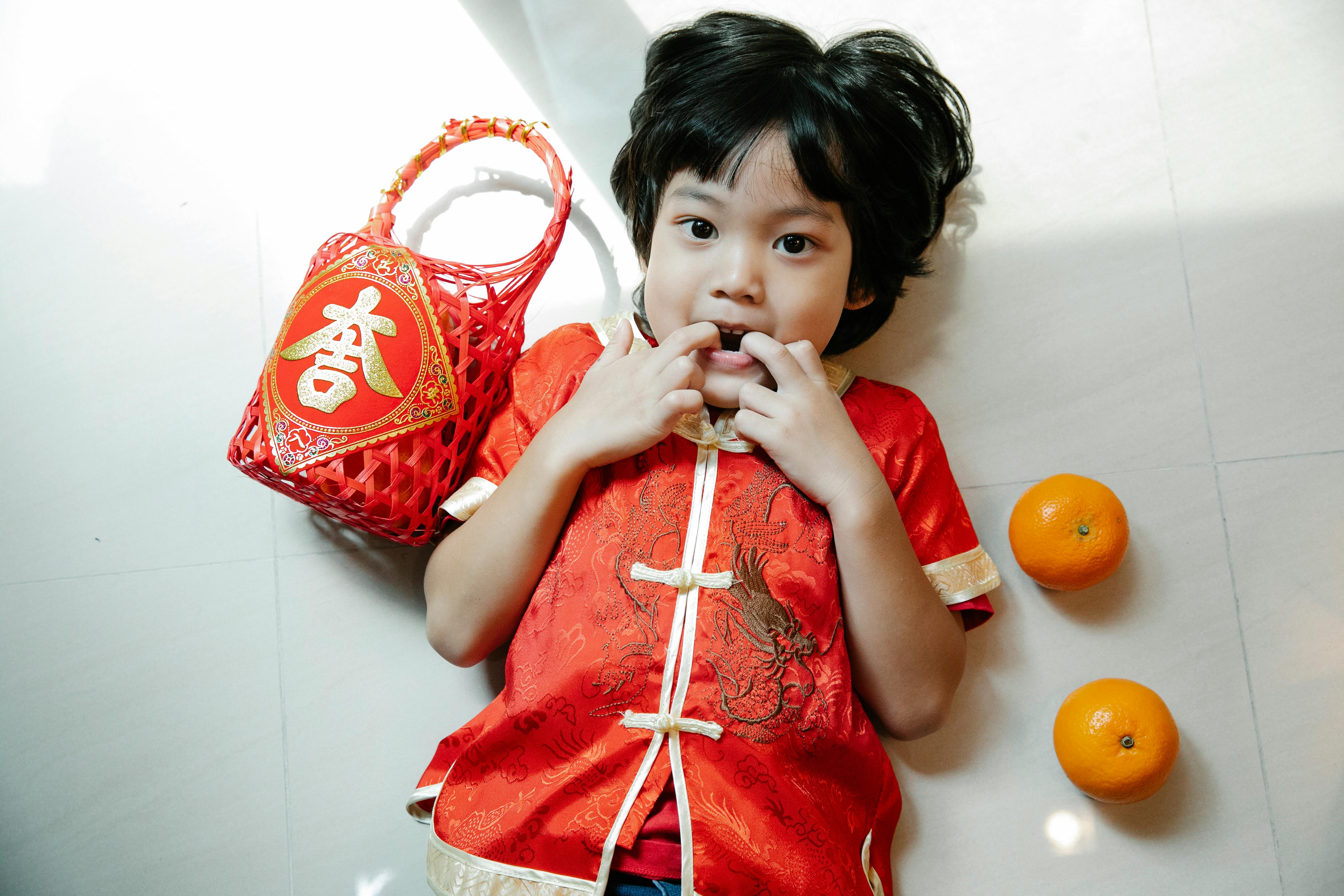 asian boy with fingers in mouth during new year holiday