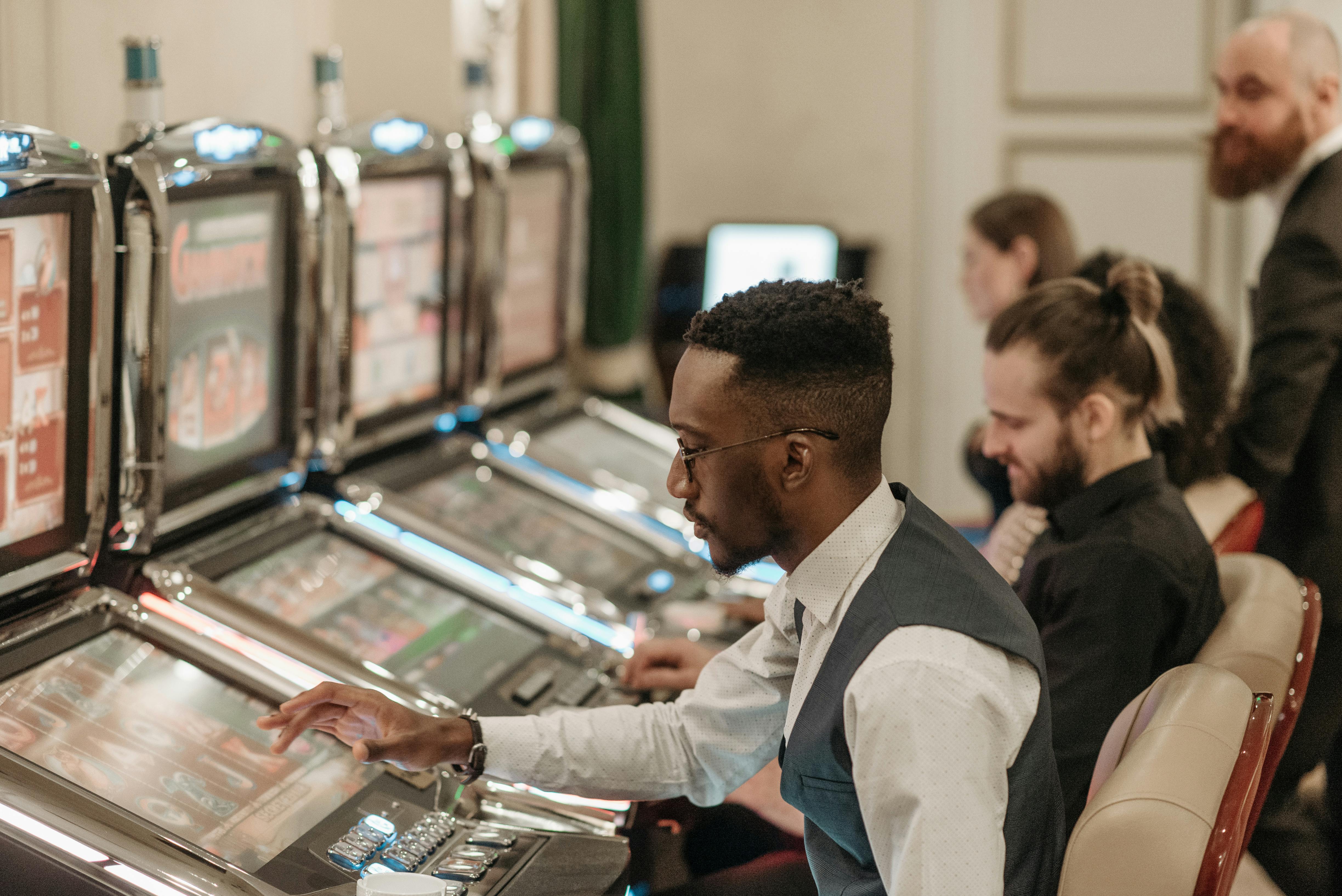 men playing slot machines in the casino