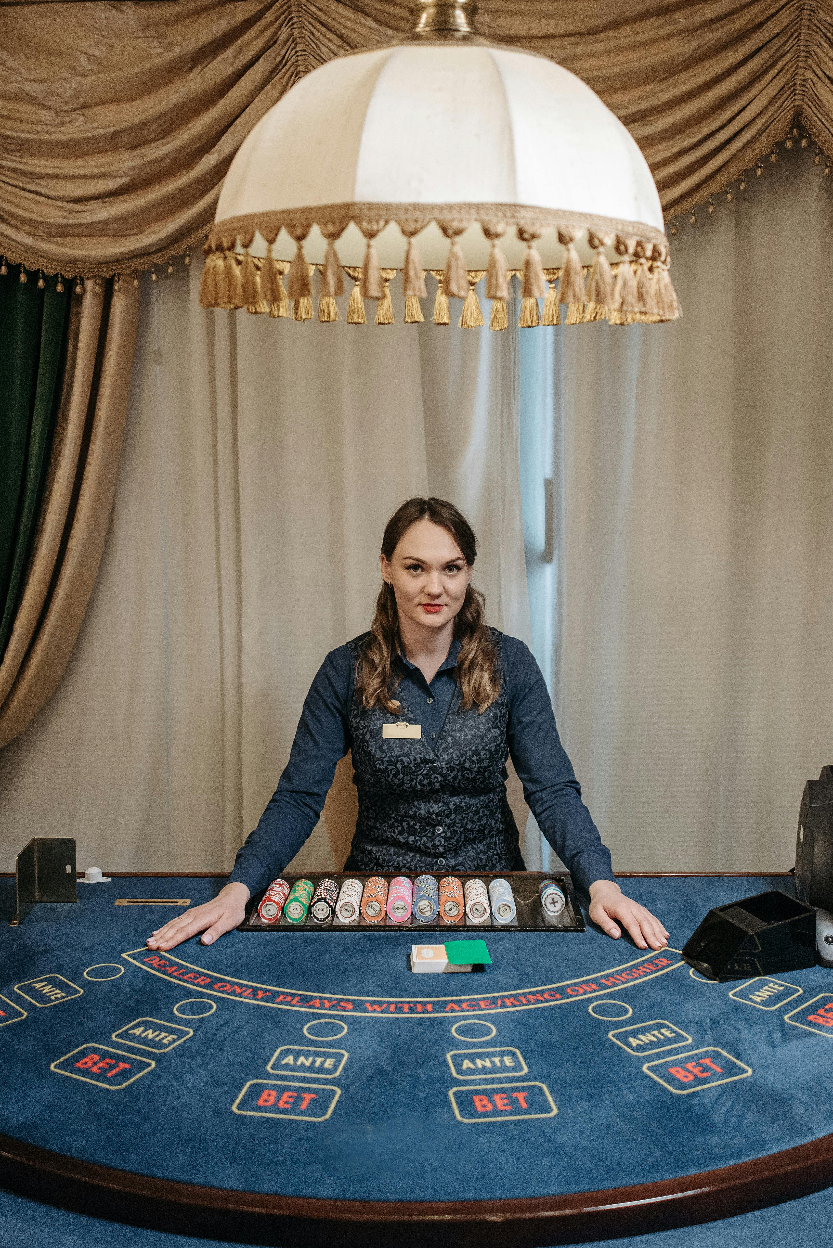 a card dealer sitting by the table