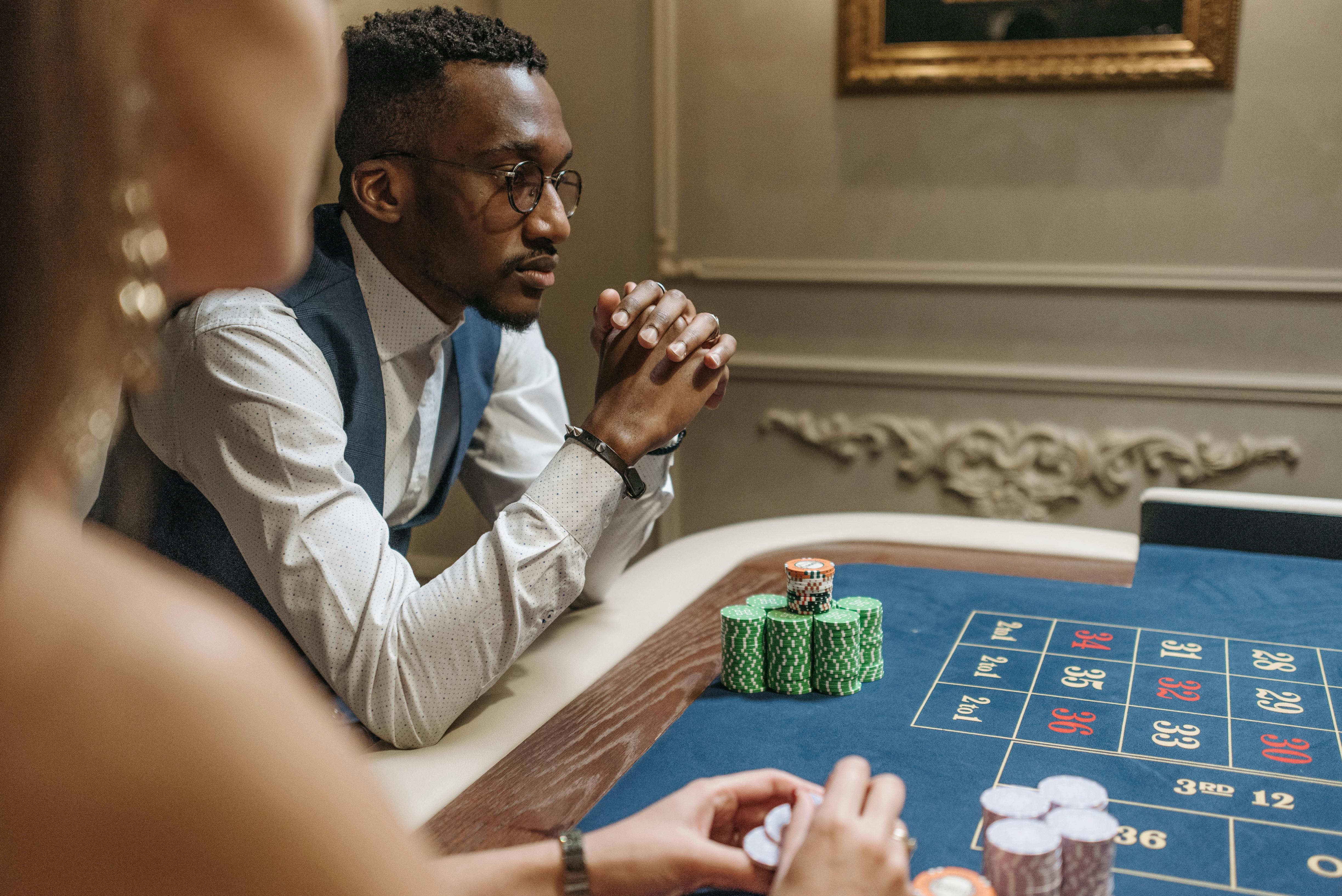 man wearing eyeglasses playing poker