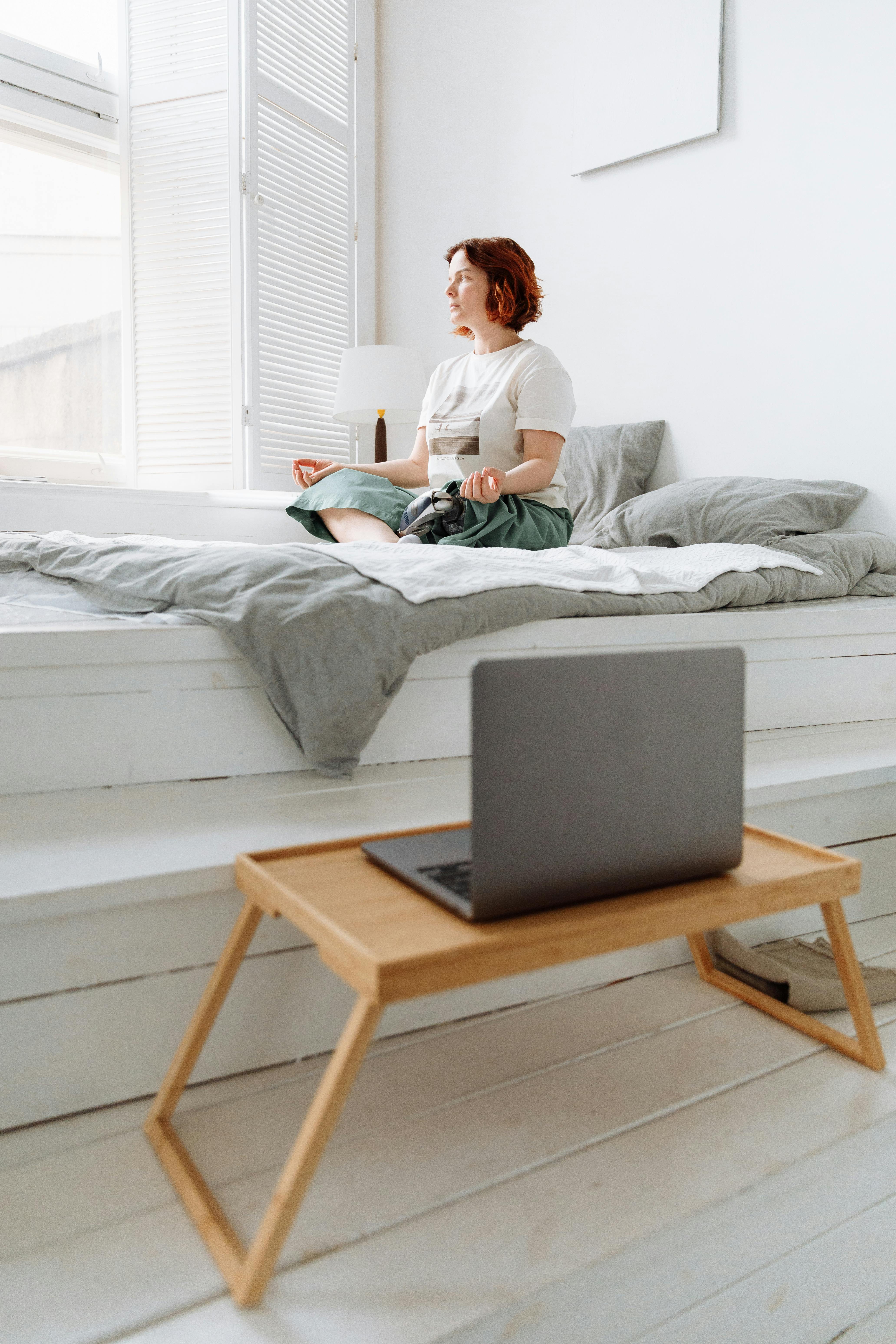 woman meditating in bed