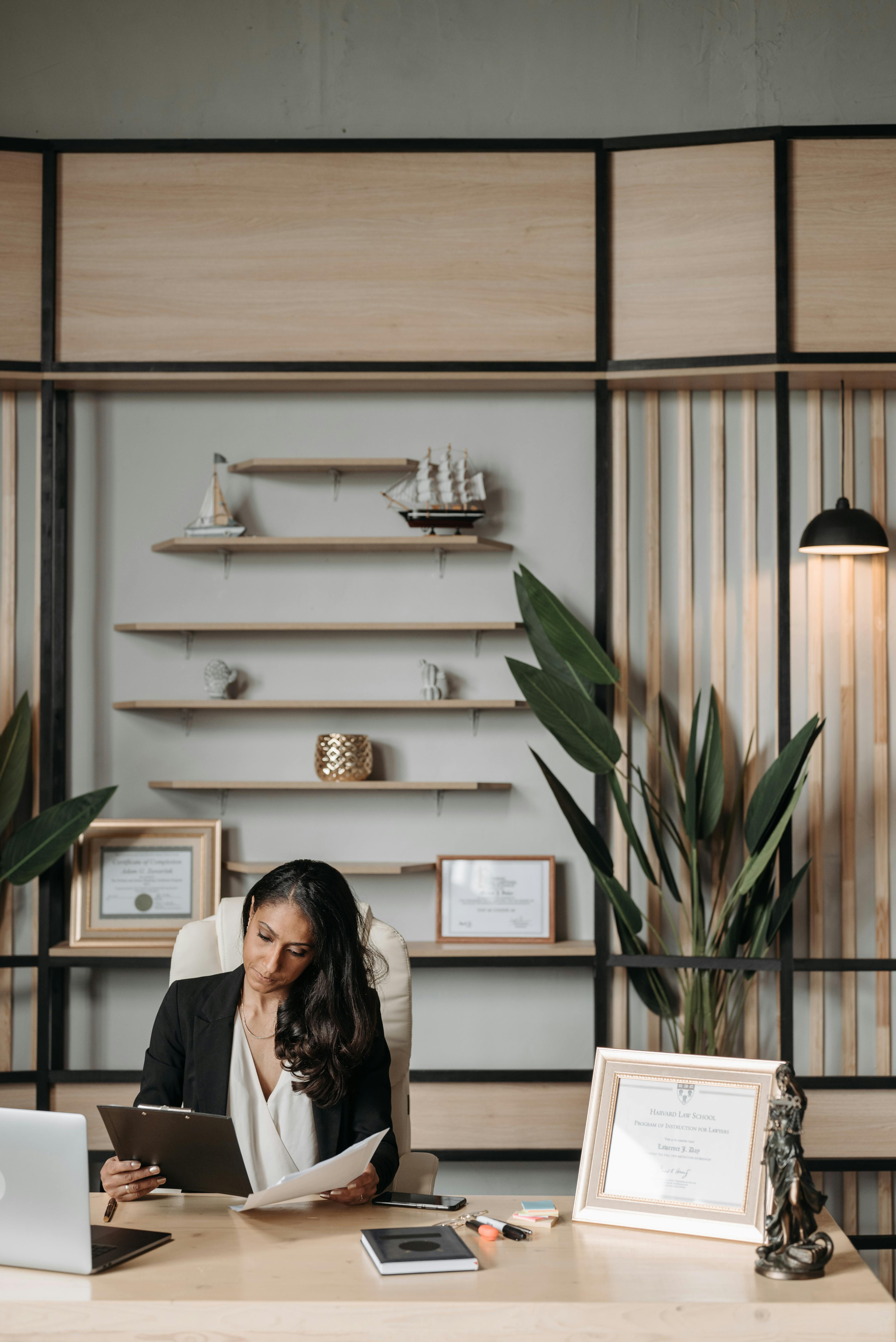 a woman reading documents in her office