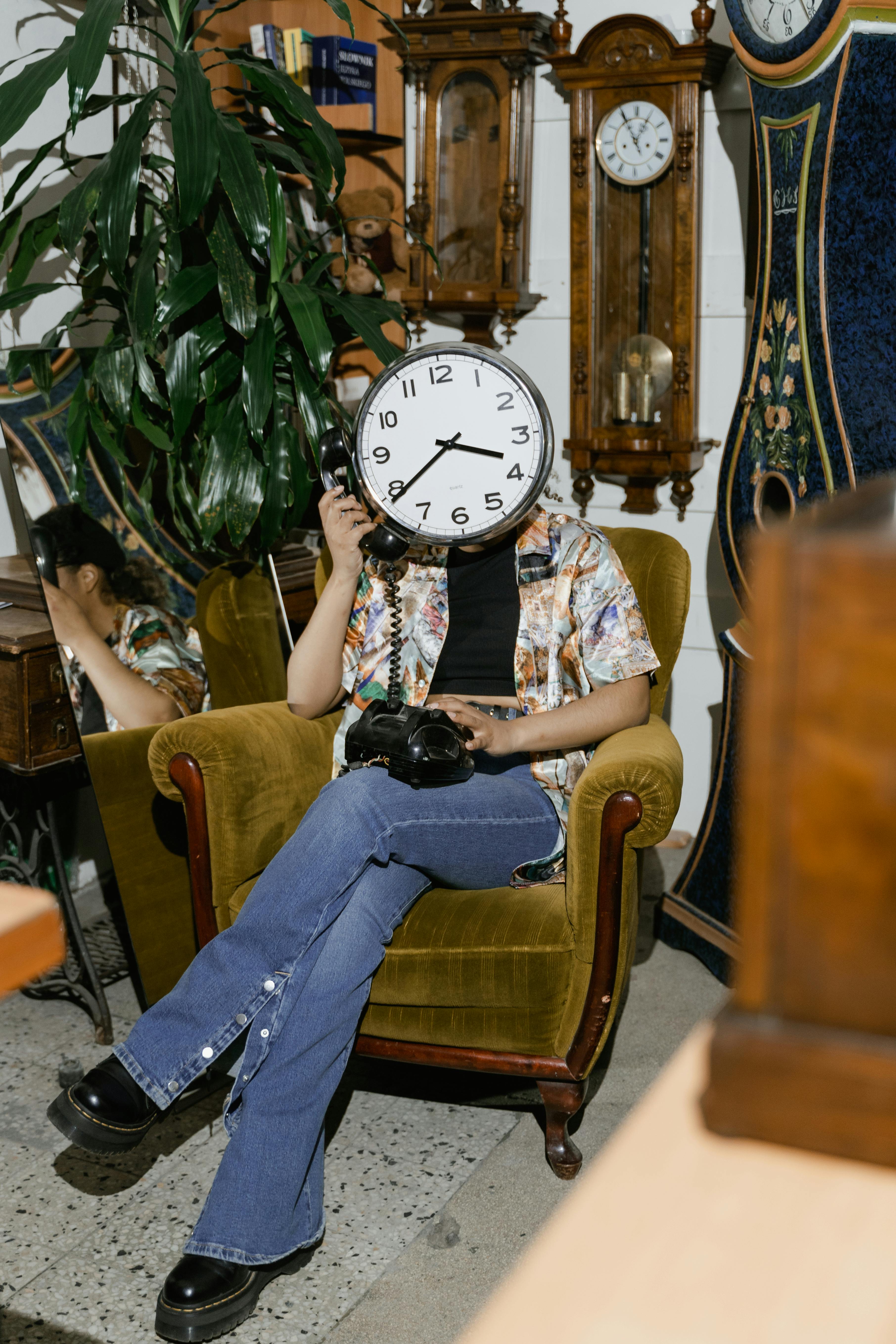 woman with a clock head using an analogue telephone