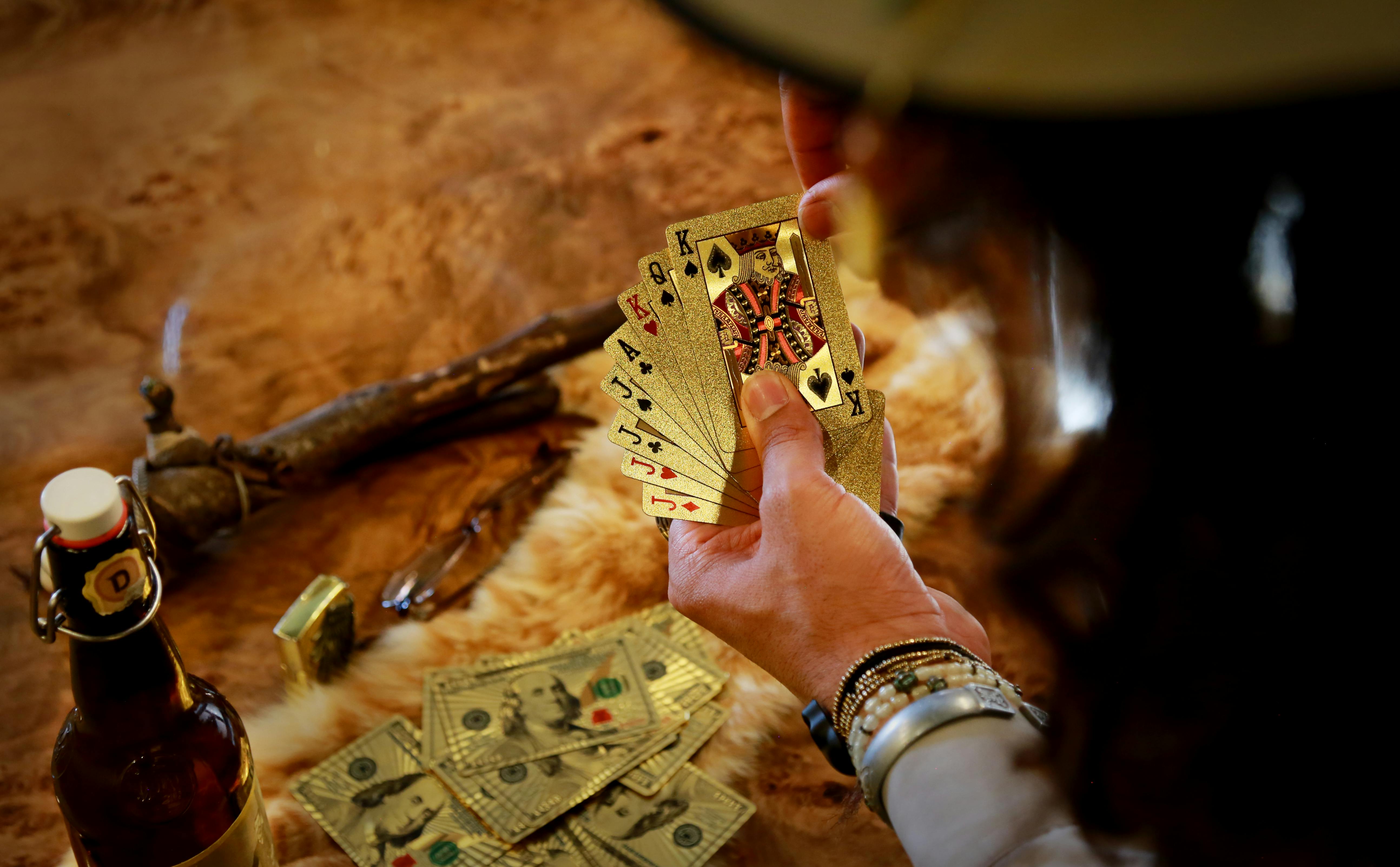 person holding playing cards