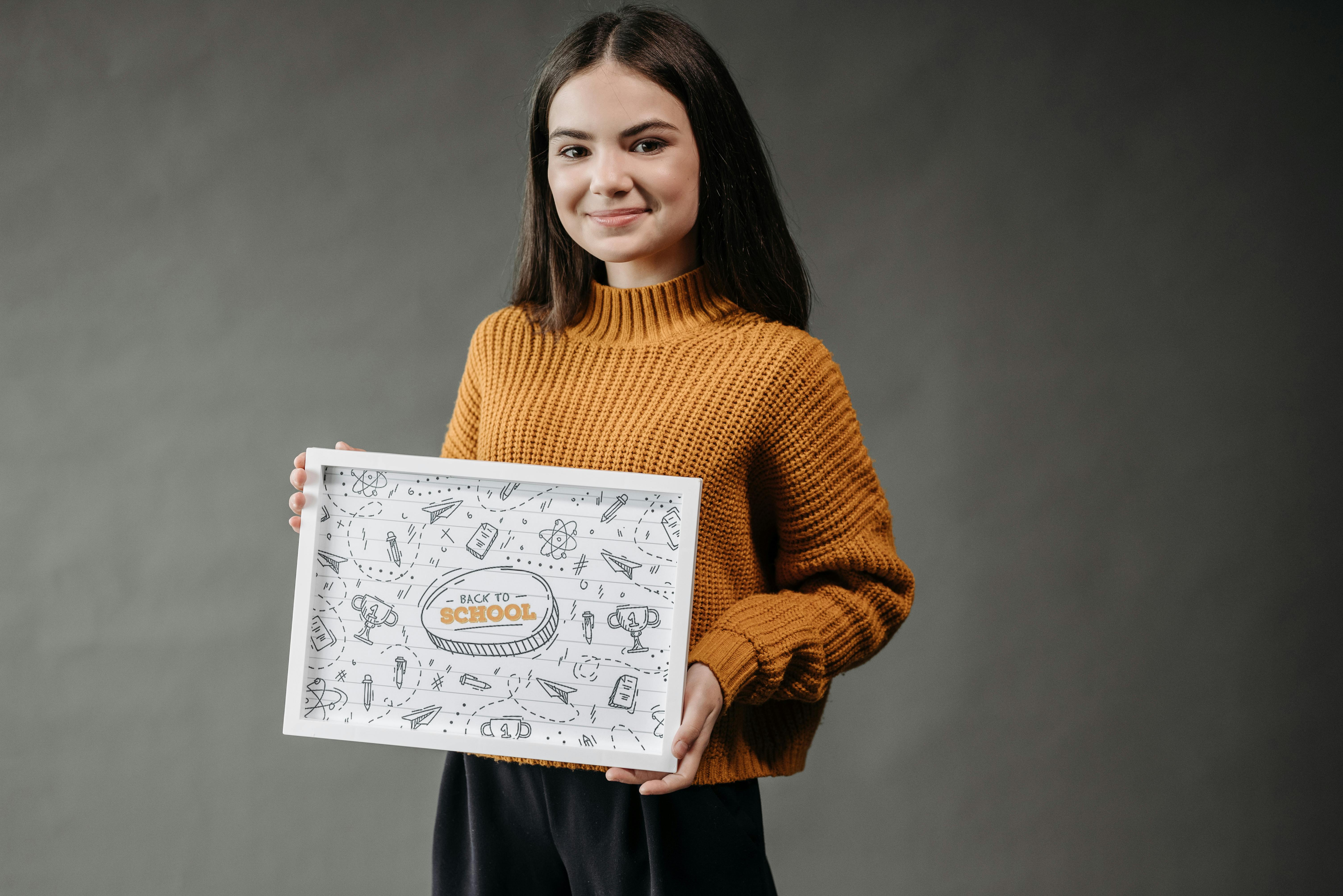 a girl holding a poster