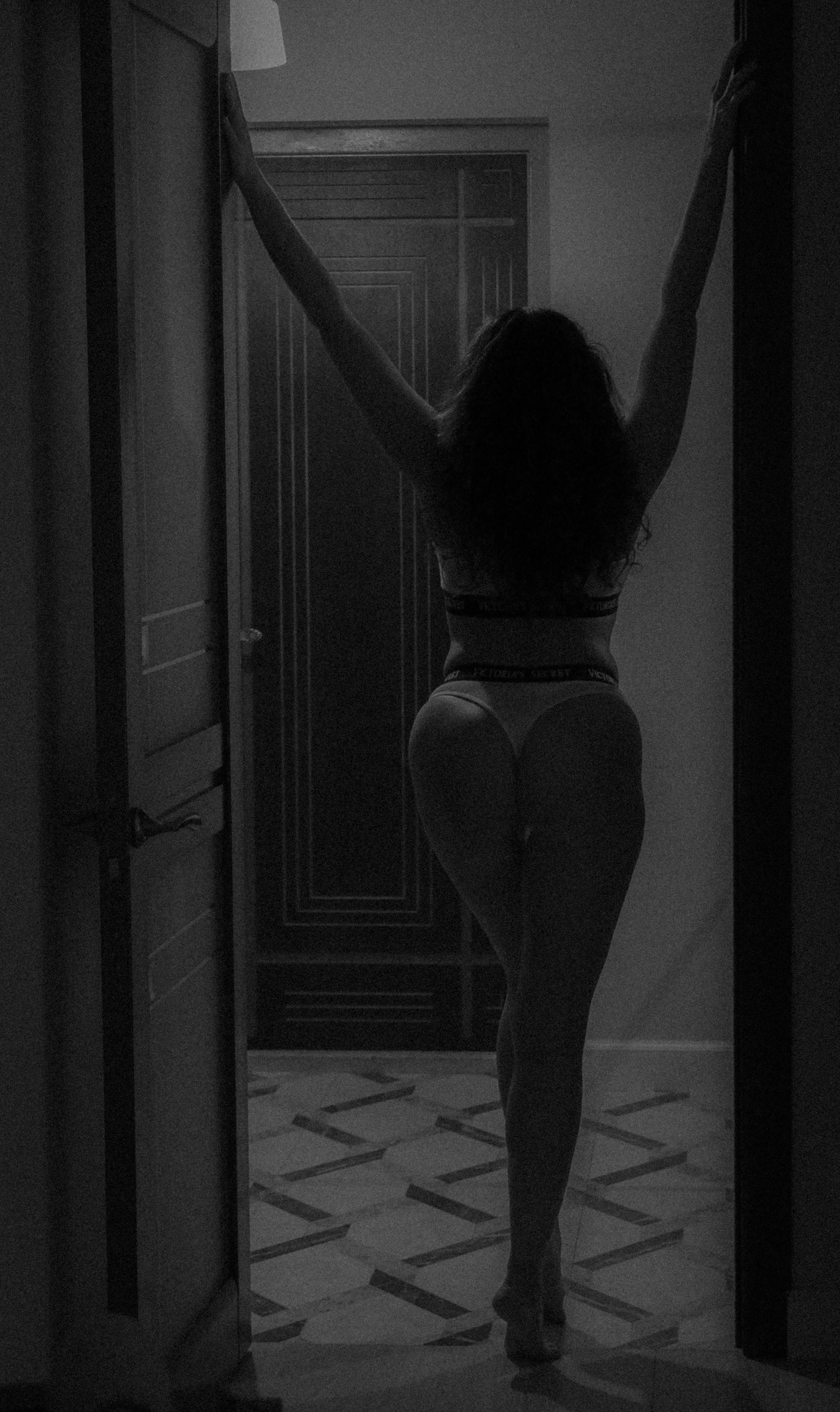 woman in white panty standing in the doorway