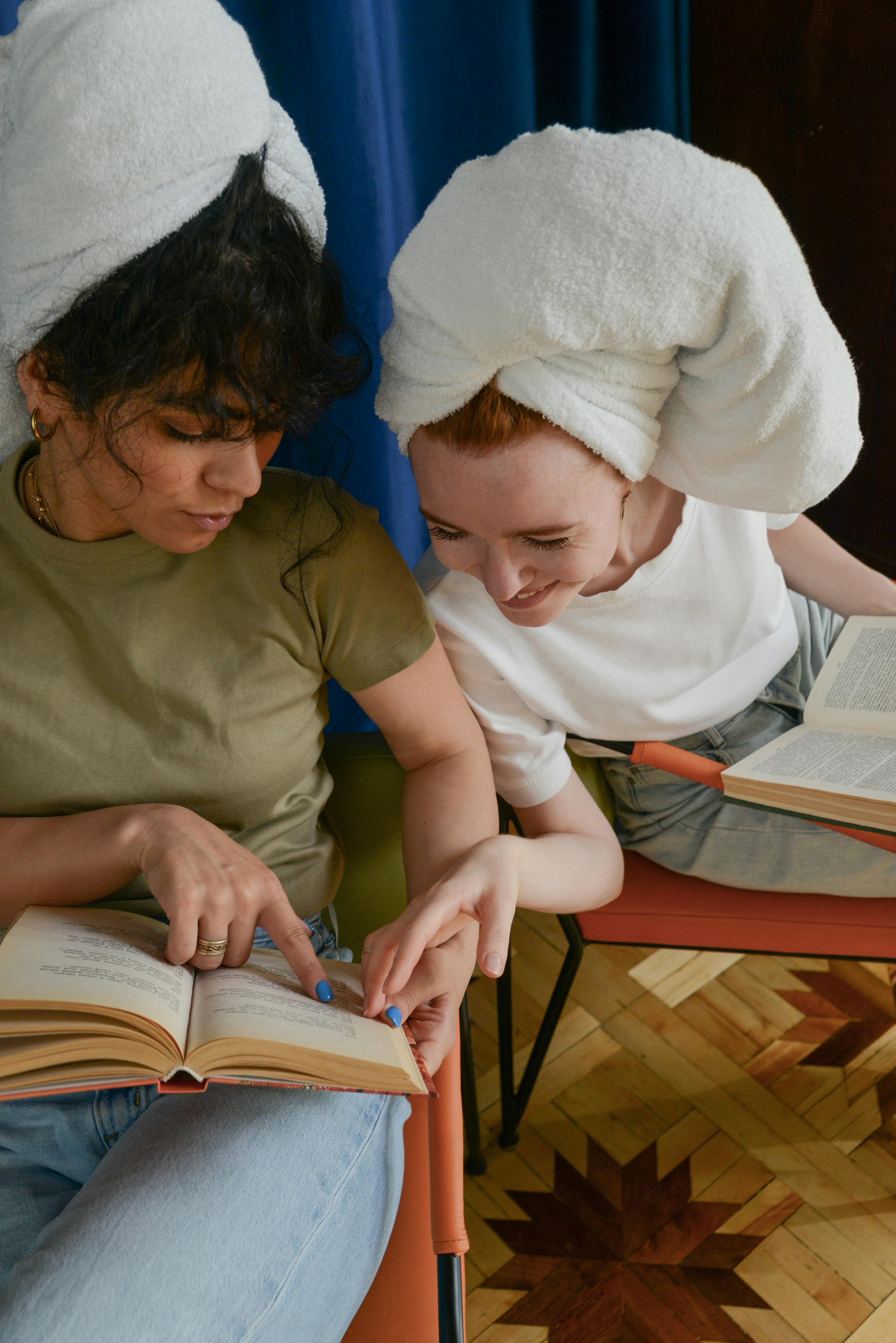 best friends reading a book together