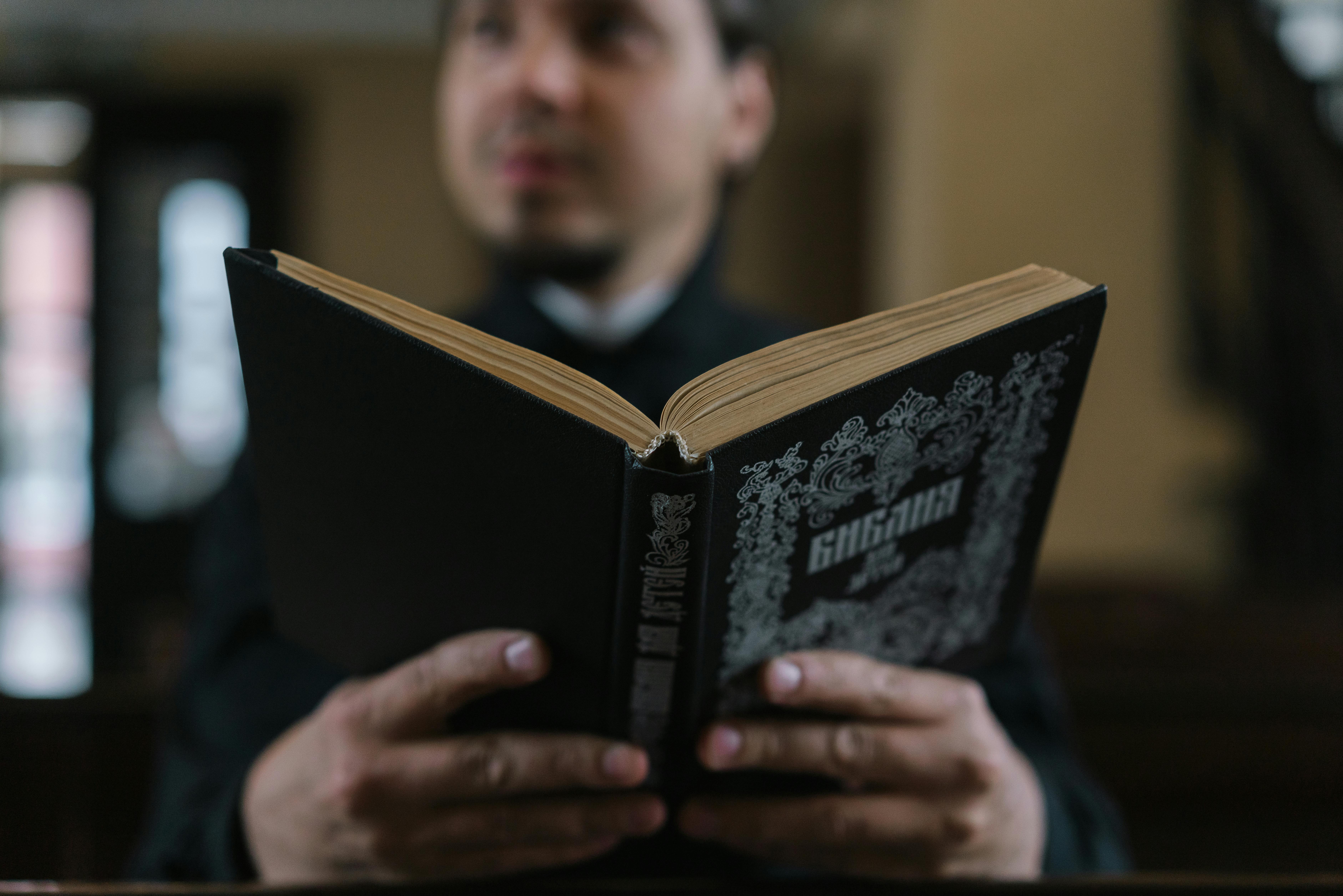 person holding a black open book