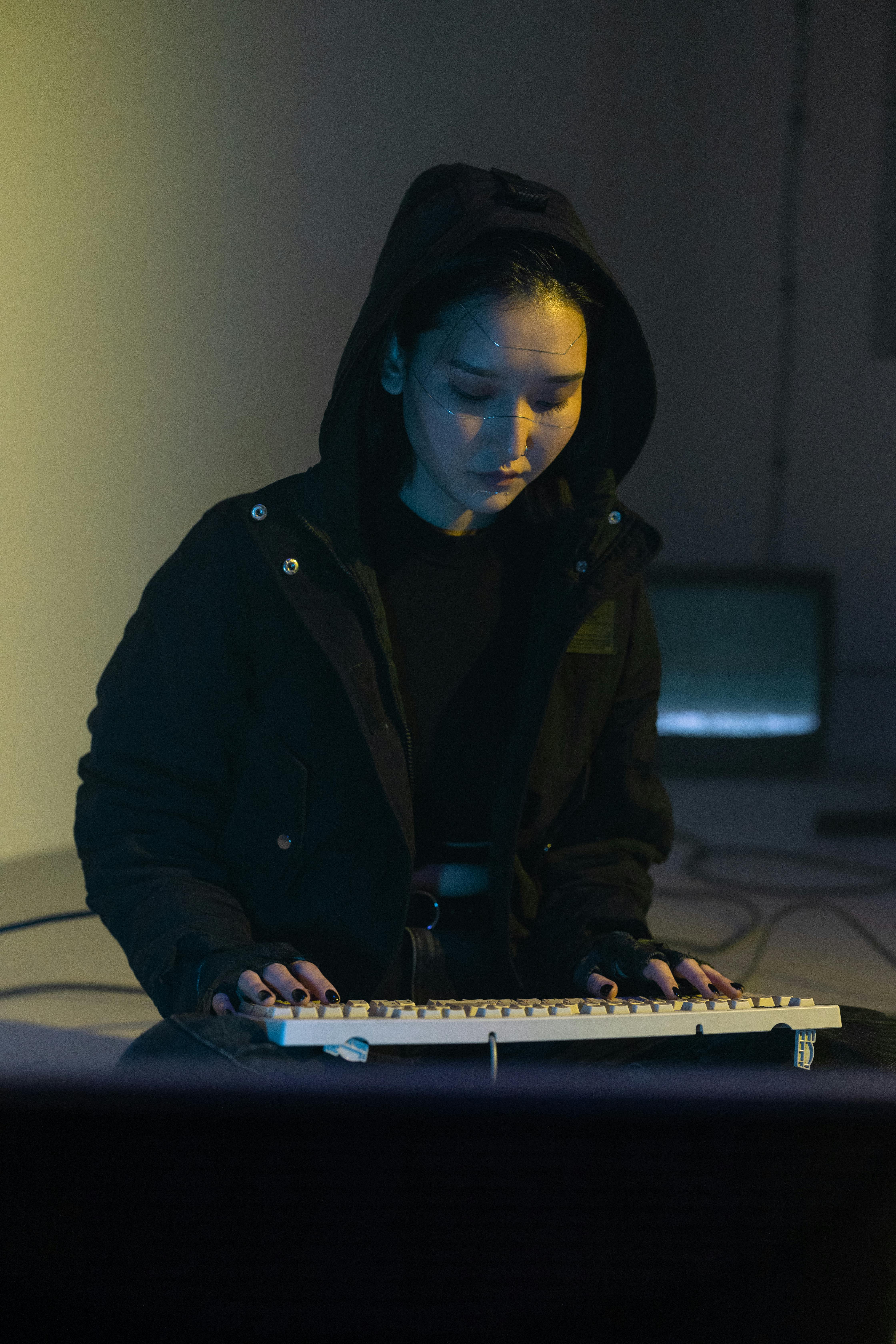 woman in black jacket using keyboard