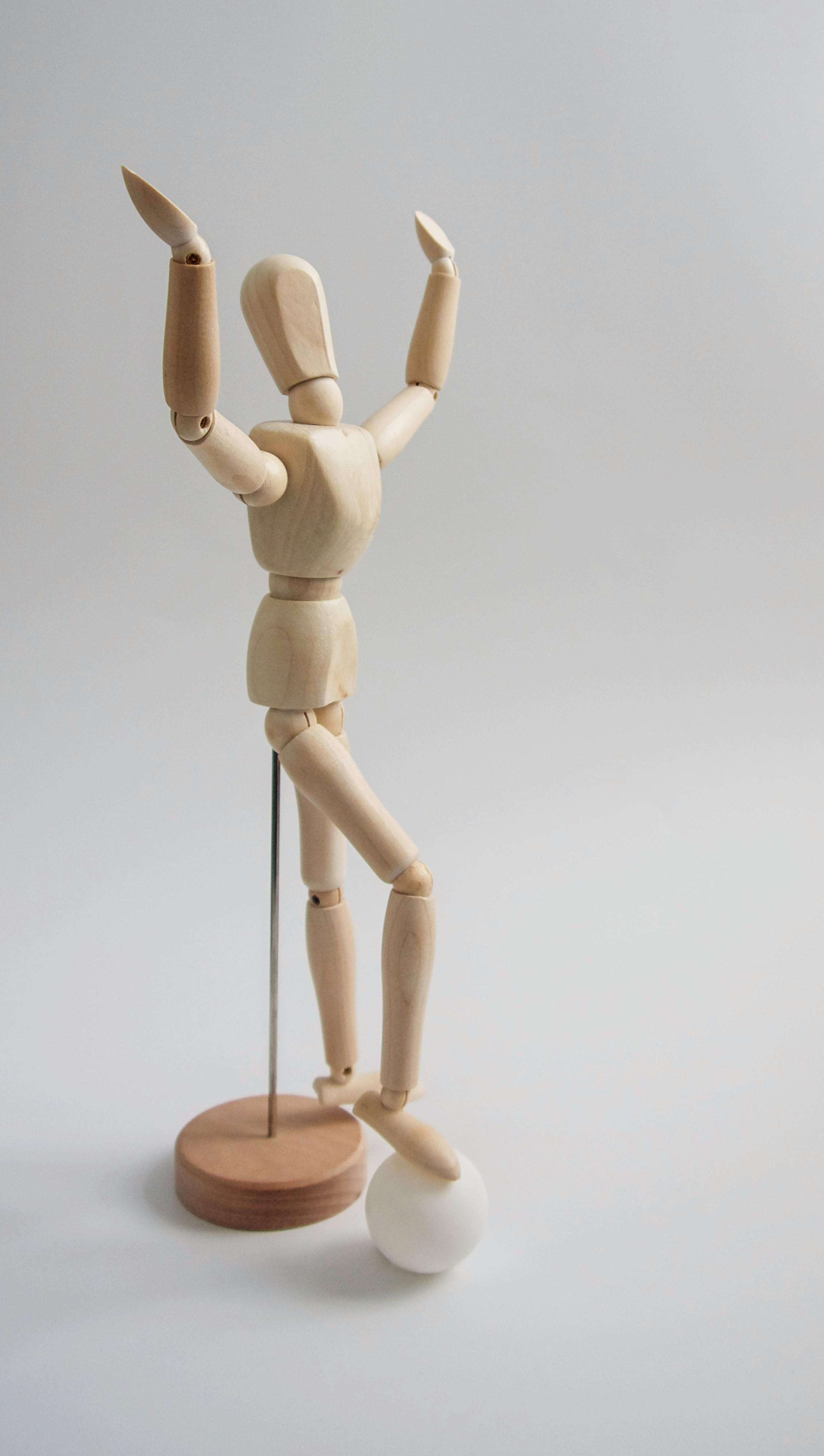 wooden human figure on white table