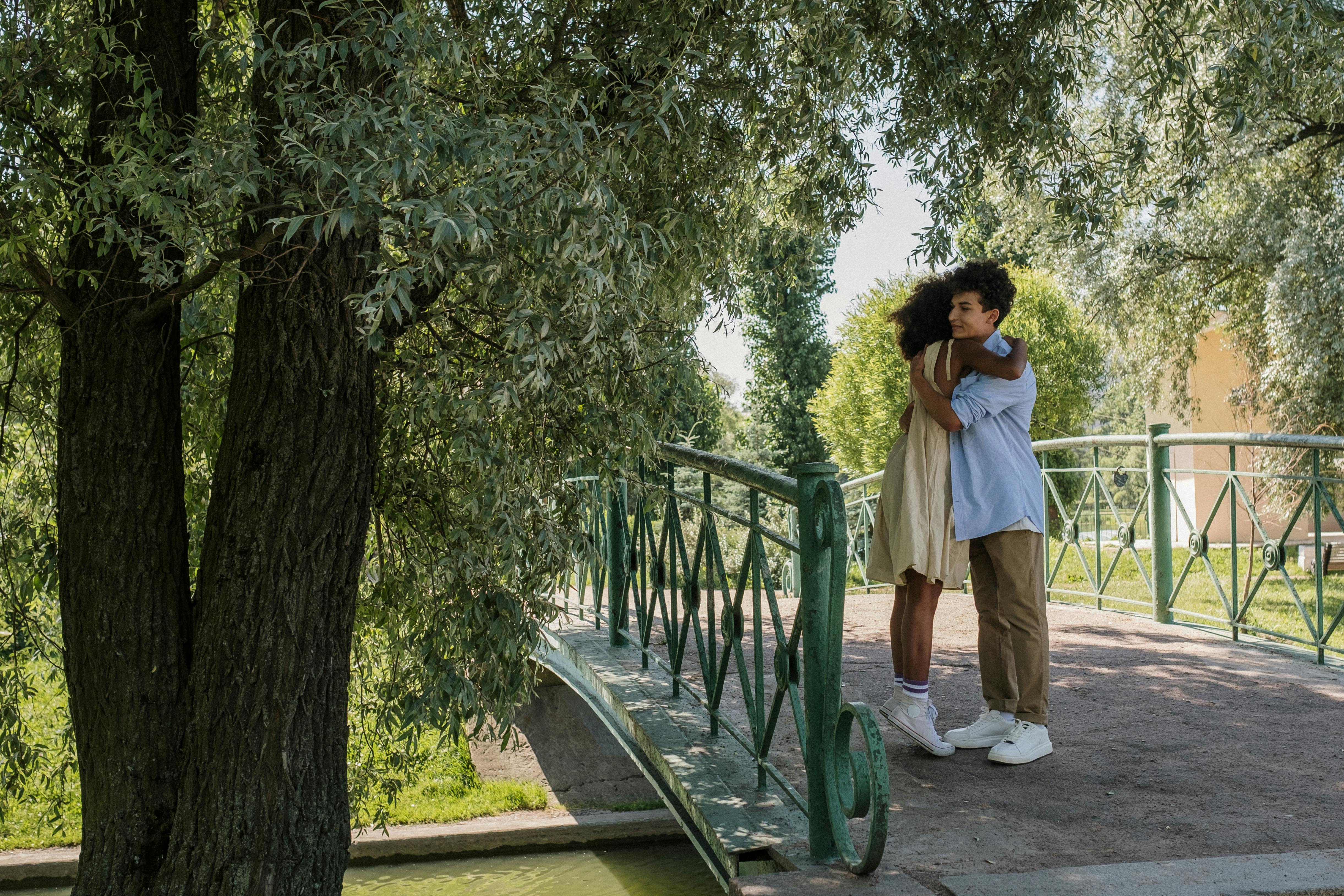 young couple hugging on the bridge