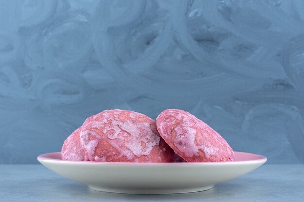 Free photo close up photo pink delicious cookies on plate over grey.