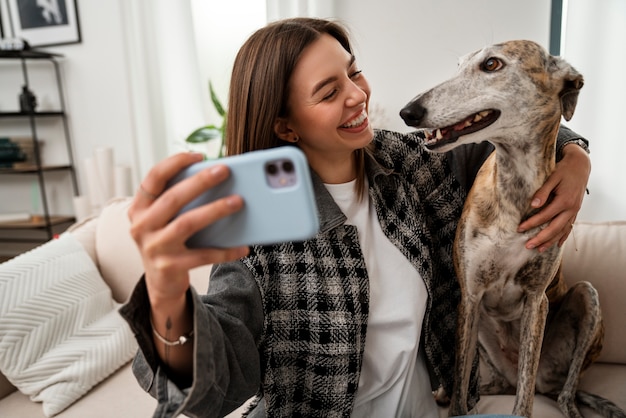 Free photo front view woman taking selfie with dog