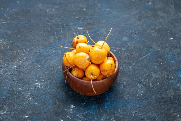 Free photo fresh yellow cherries ripe and sweet fruits on dark floor fruit berry fresh mellow