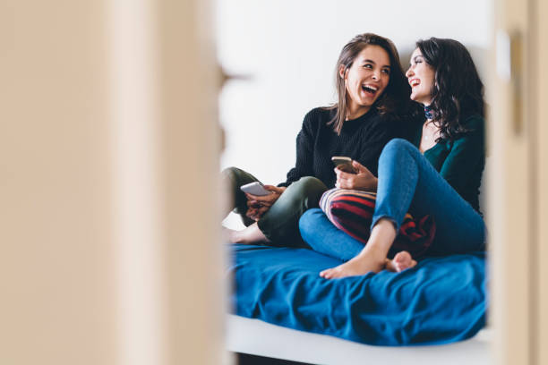 two young women friends sharing happy time together - friendship stock pictures, royalty-free photos & images